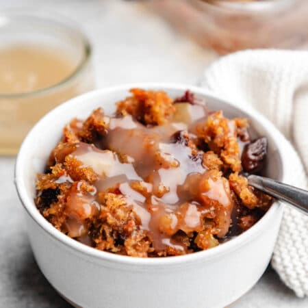 Dish of carrot pudding with a silver spoon in it.