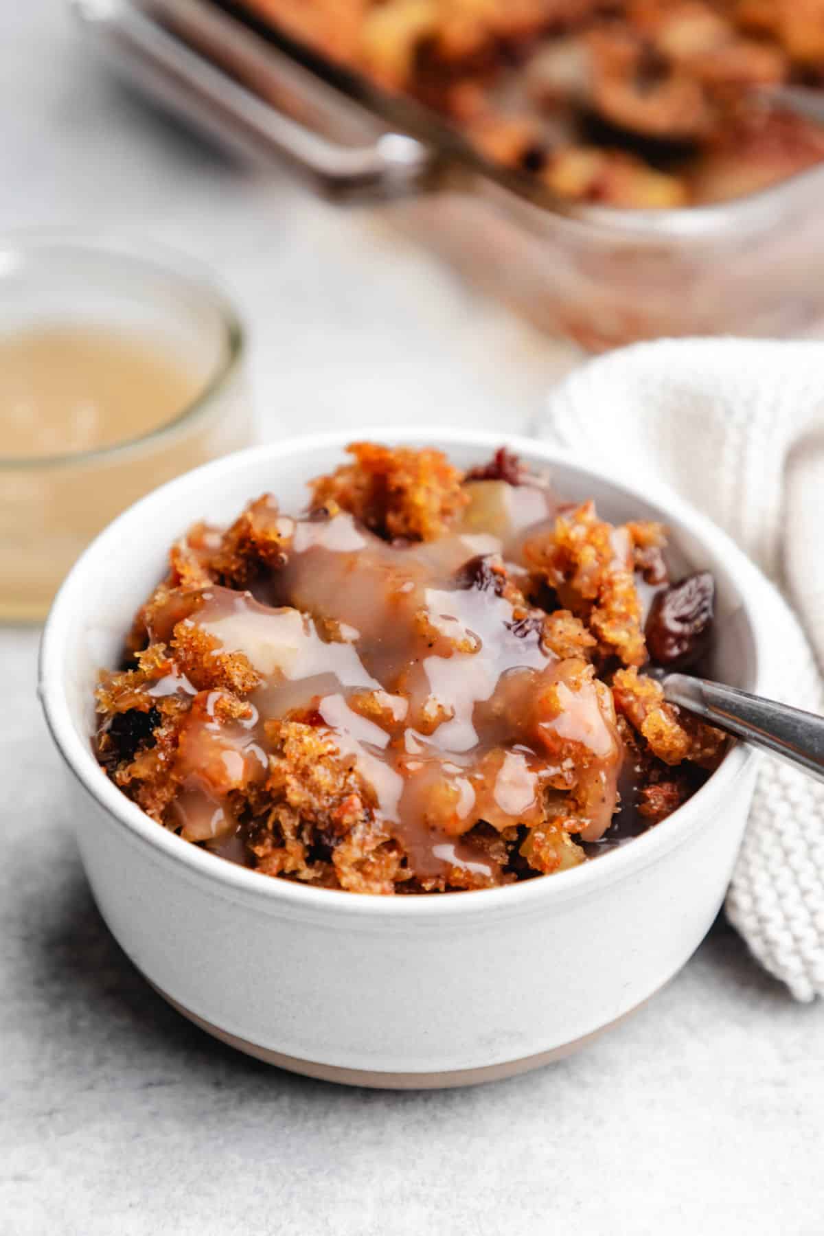 Dish of carrot pudding with a silver spoon in it.