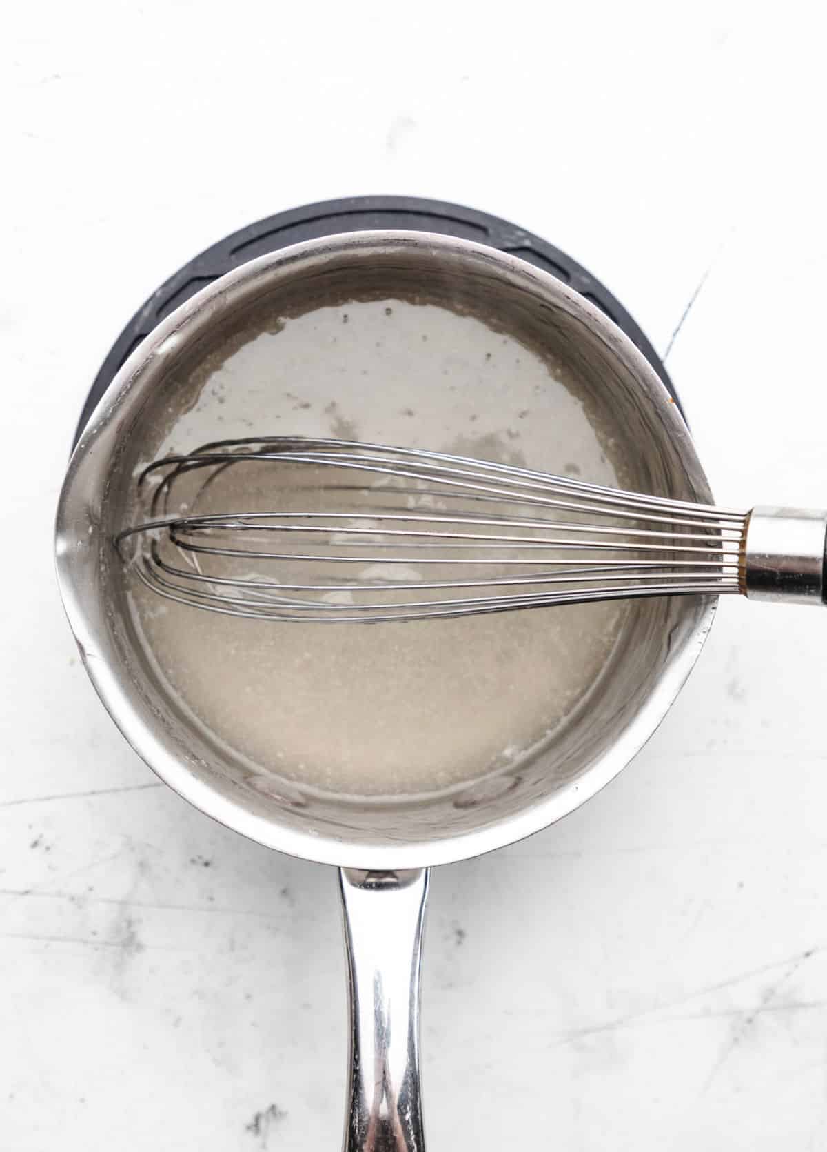 Thickened sugar sauce in a saucepan.