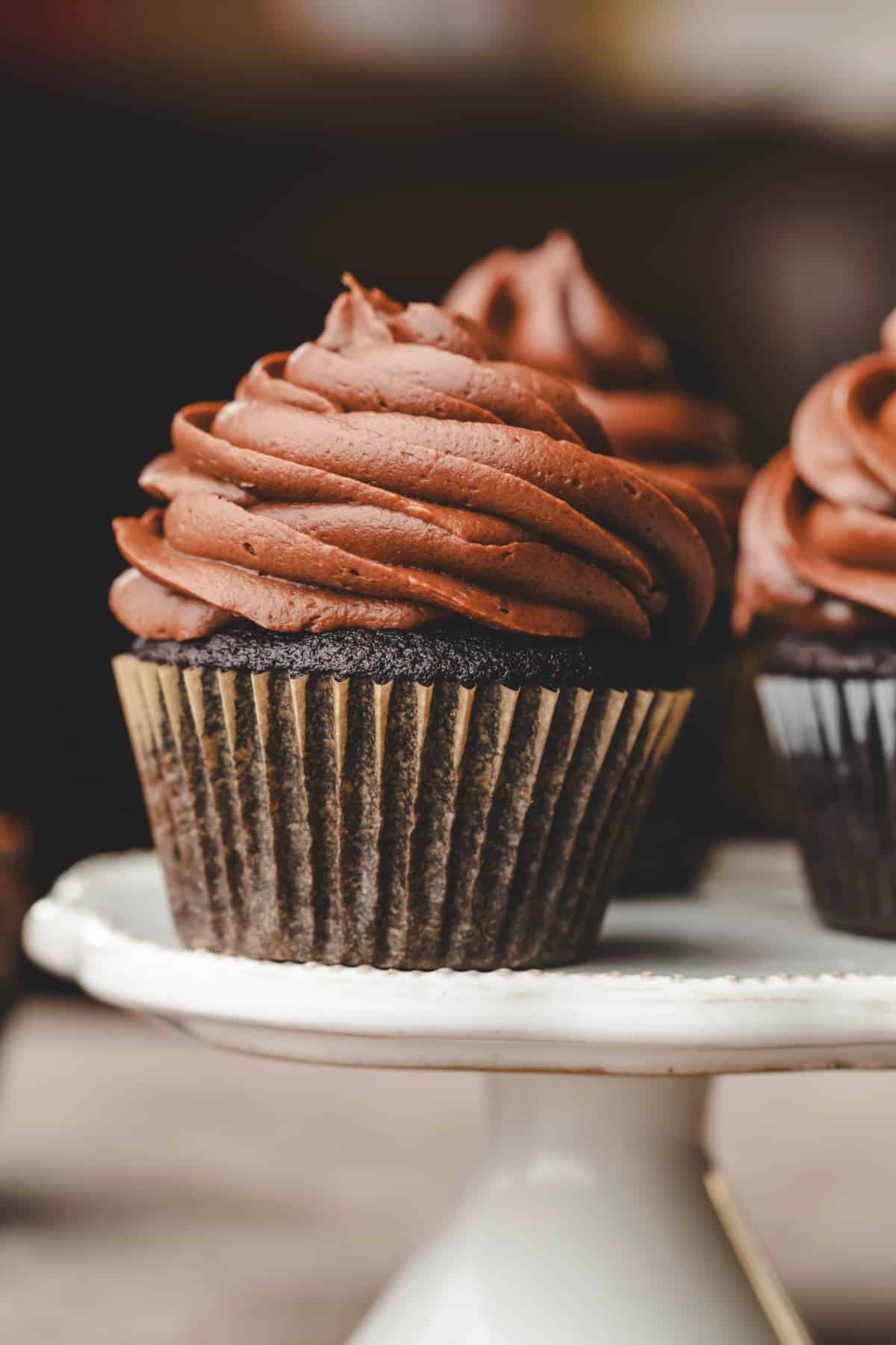 Chocolate cupcakes frosted with chocolate cream cheese frosting.
