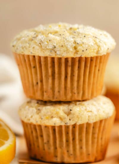 Two lemon poppy seed muffins stacked on top of each other.