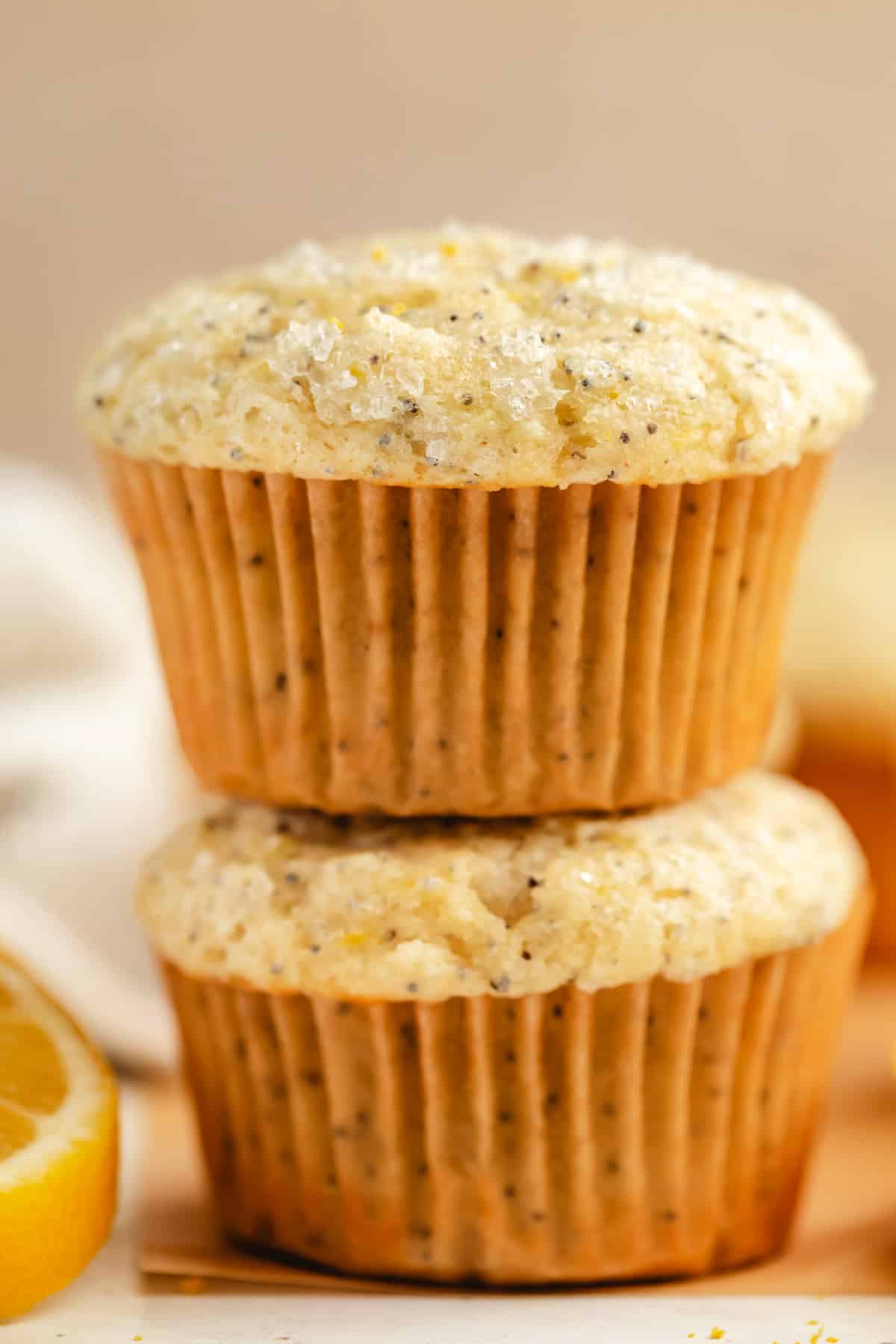 Two lemon poppy seed muffins stacked on top of each other.