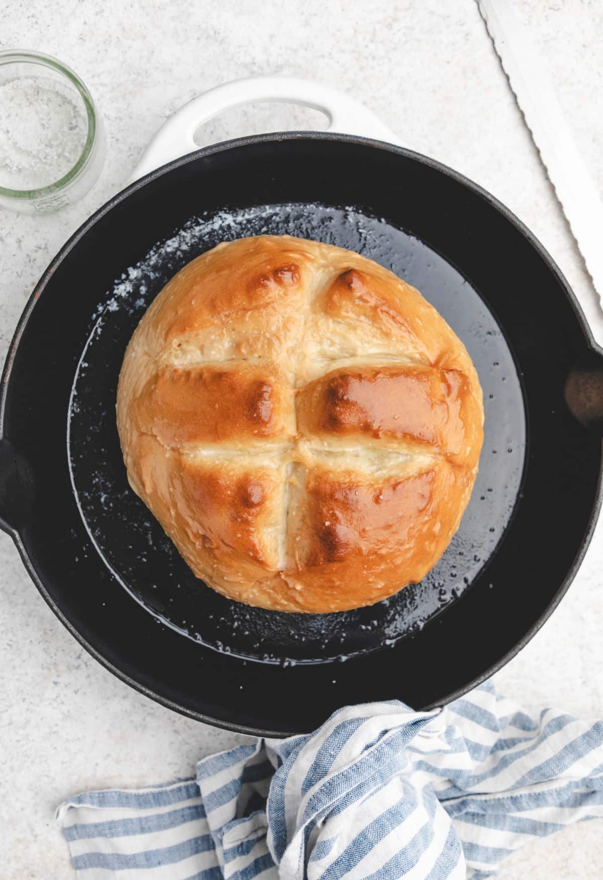 A baked loaf of skillet bread in a skillet.