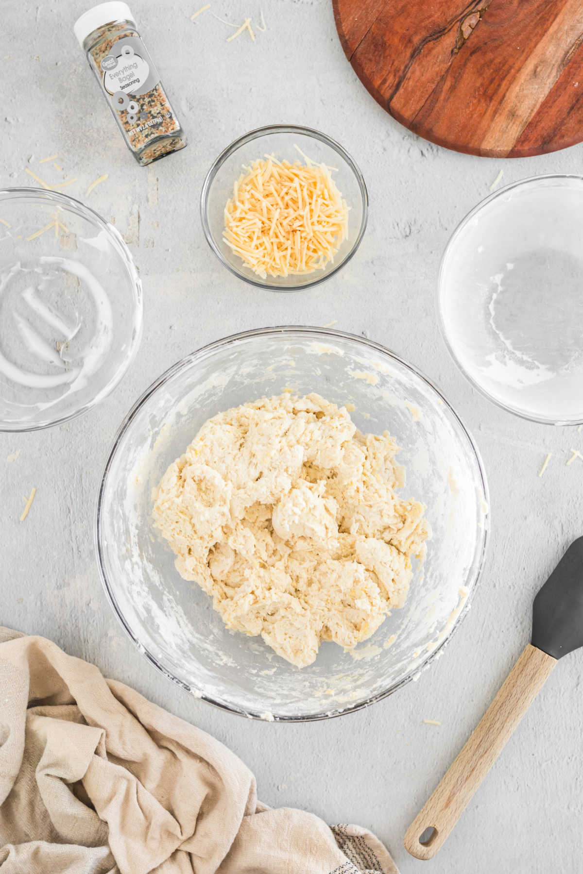 3 ingredient bagel dough in a glass mixing bowl. 