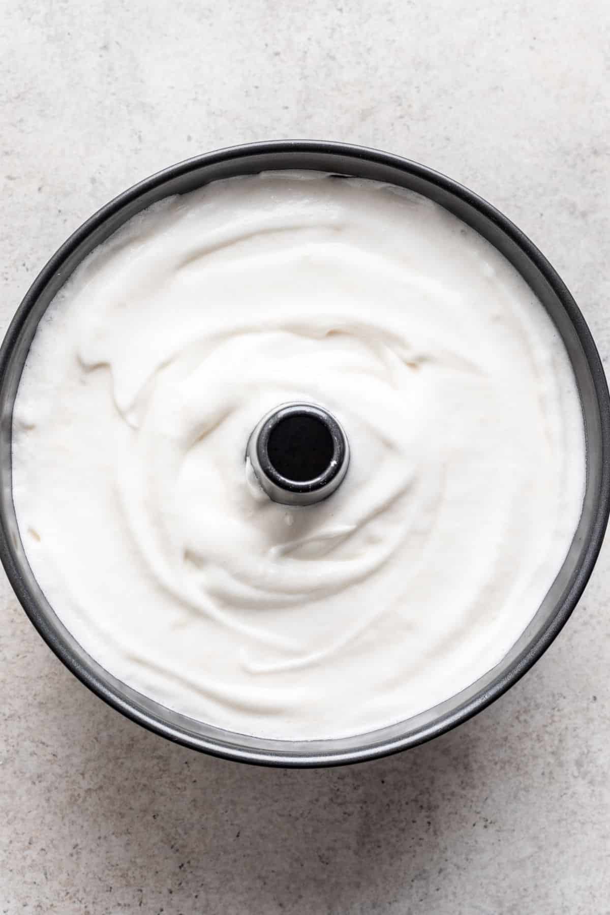 Angel food cake batter in a tube pan.