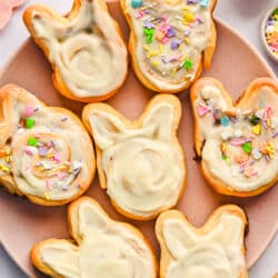 Easter bunny cinnamon rolls on a pink plate.