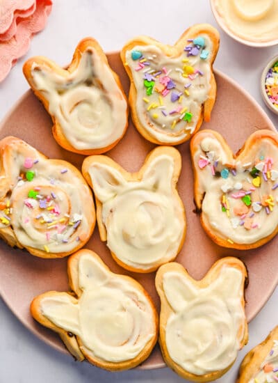 Easter bunny cinnamon rolls on a pink plate.