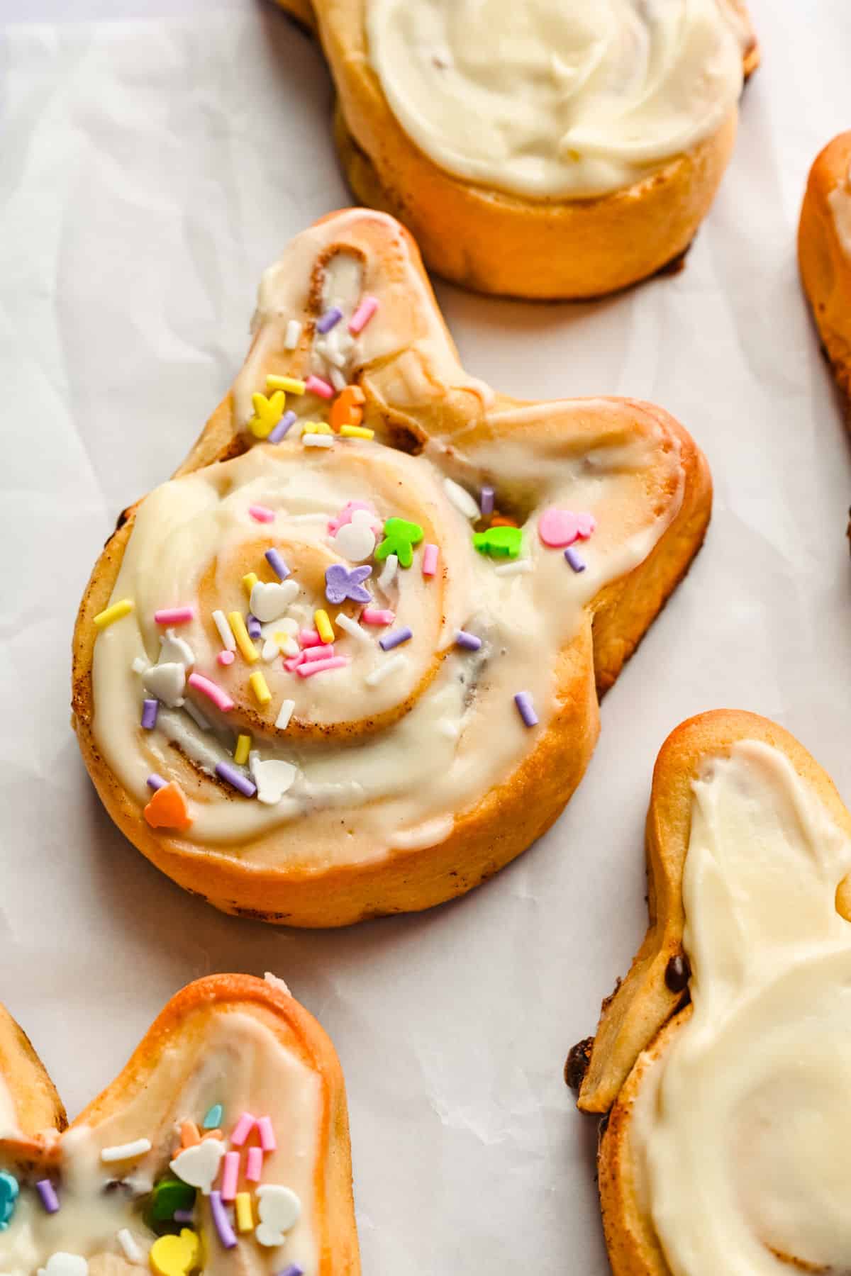 An Easter bunny cinnamon roll topped with Easter sprinkles.