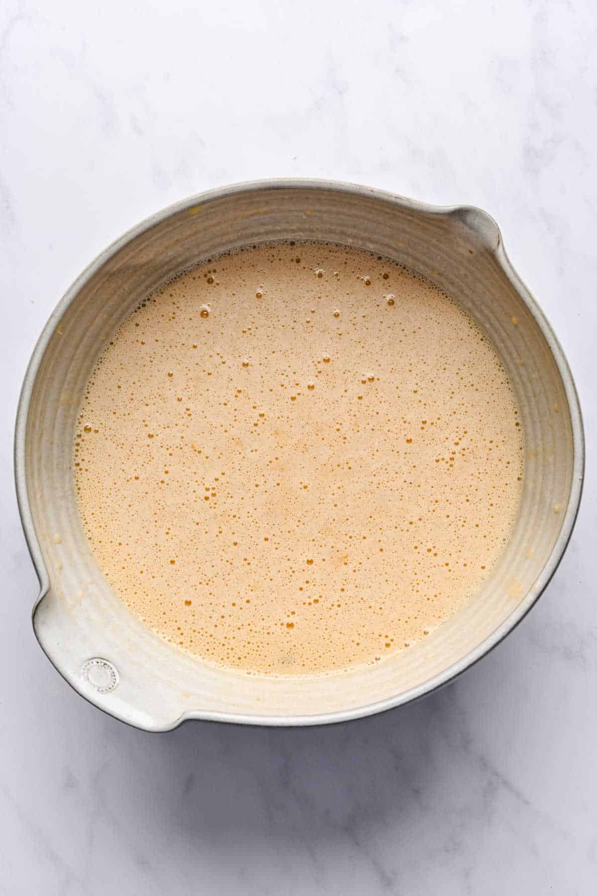 Pineapple bananas and oil mixed into egg and sugar mixture.