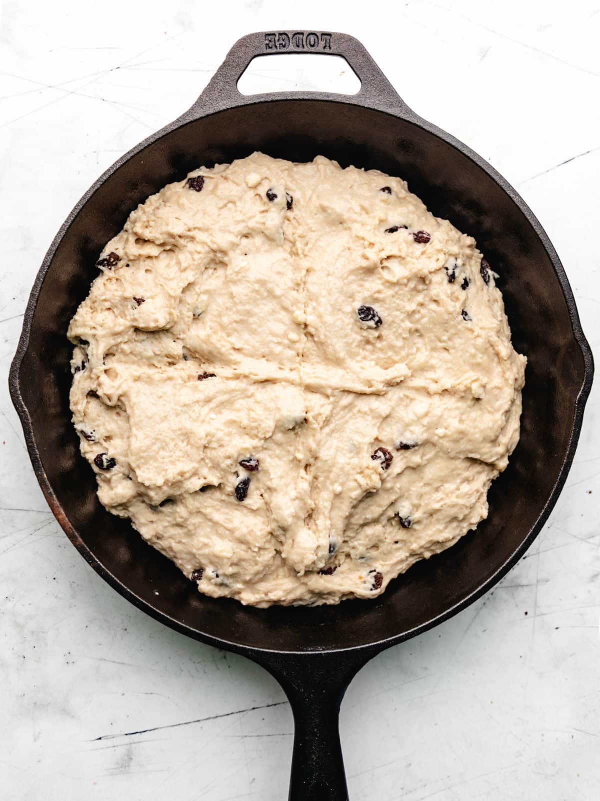 Irish soda bread dough with a cross cut into it. 