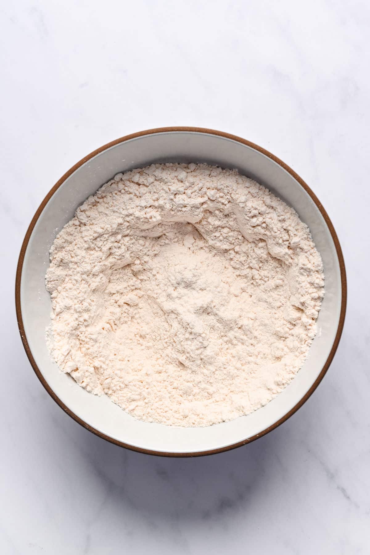 Dry ingredients for lemon loaf cake in a bowl.