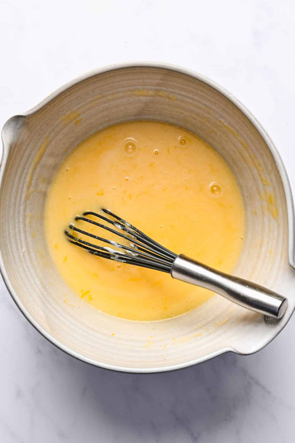 Oil sugar and sour cream in a mixing bowl.