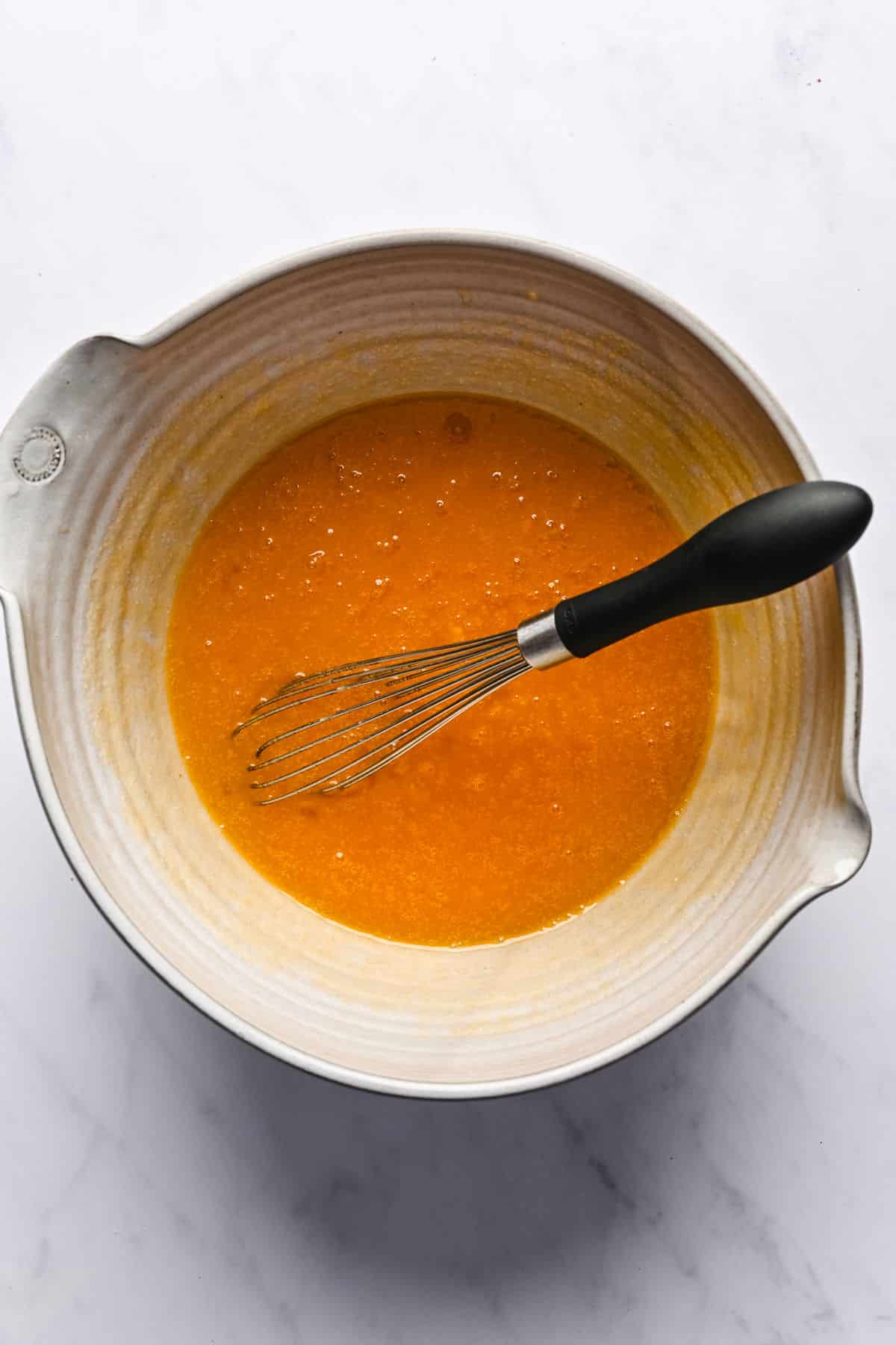 Wet ingredients for peanut butter brownies in a mixing bowl. 