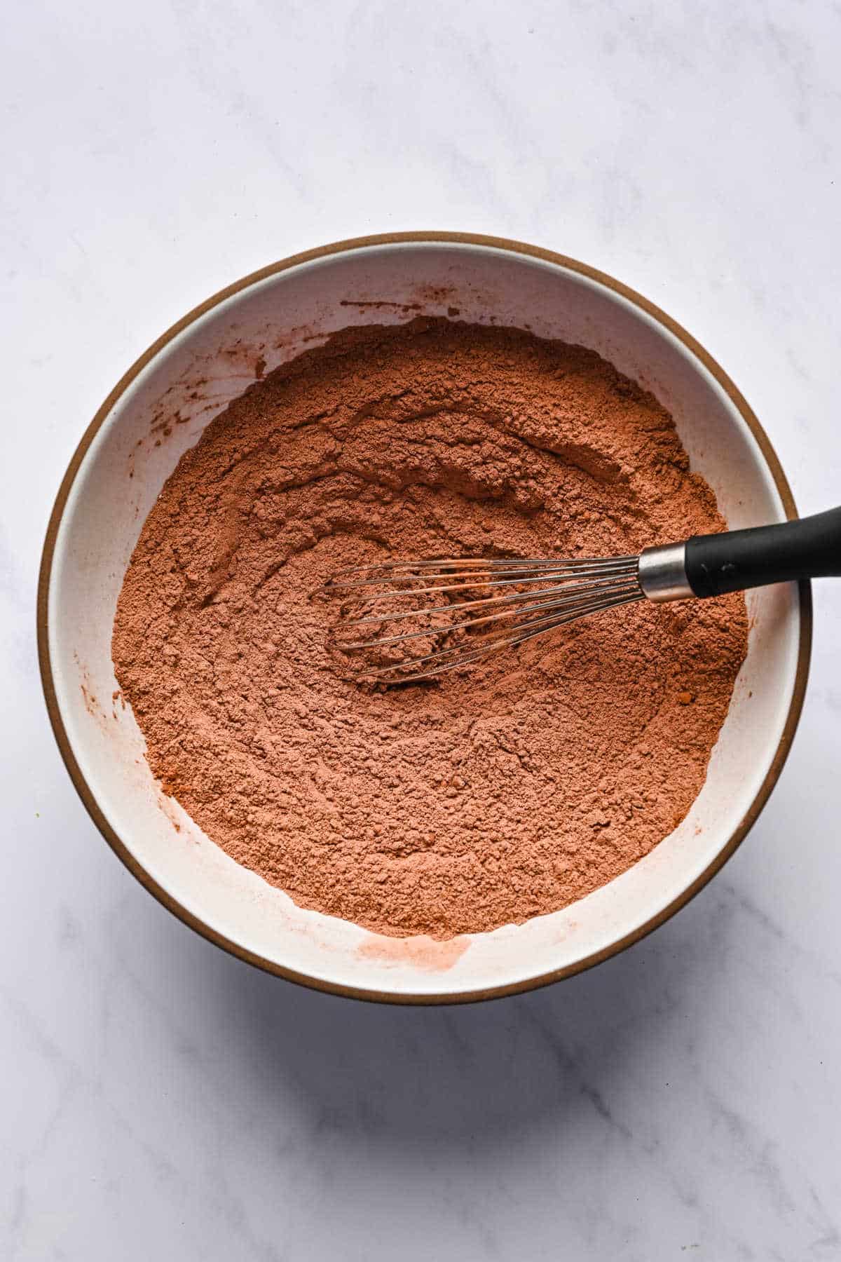Dry ingredients on top of wet ingredients for peanut butter brownies.