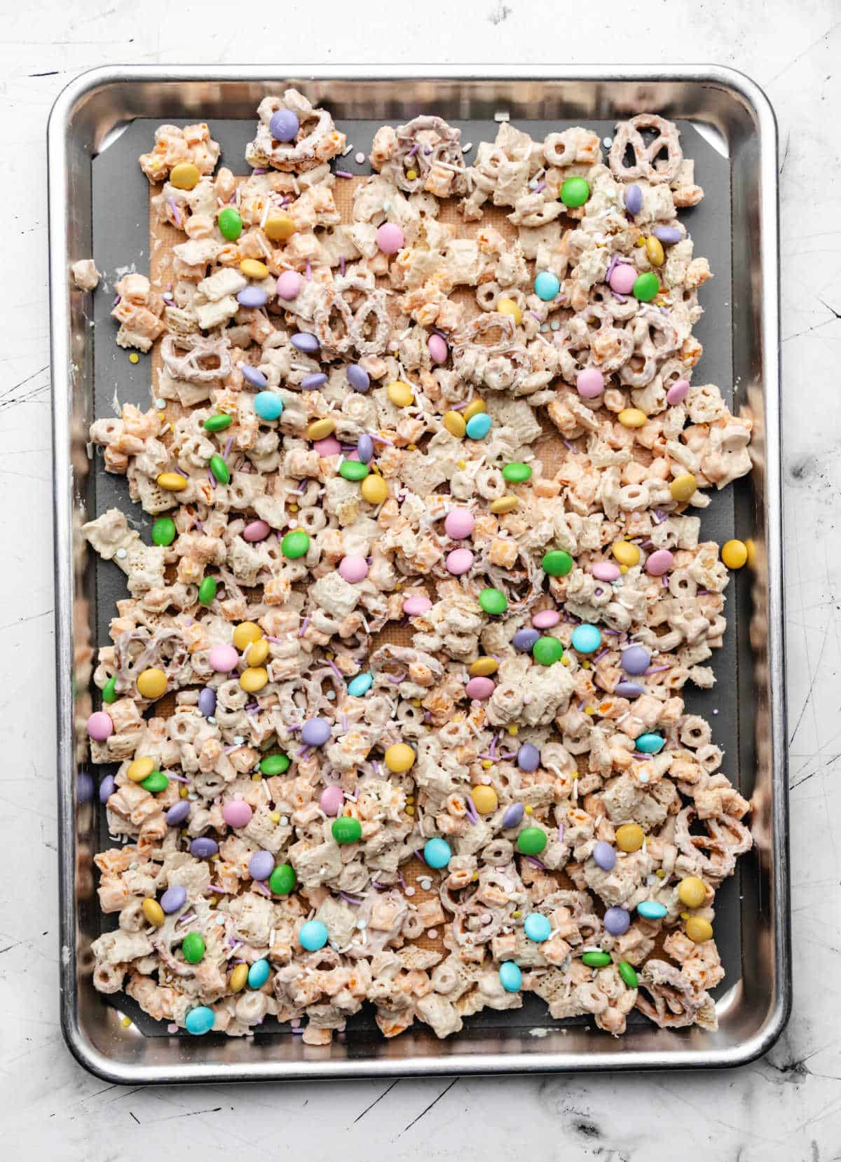 Sprinkles and M&Ms on top of white chocolate cereal mixture.