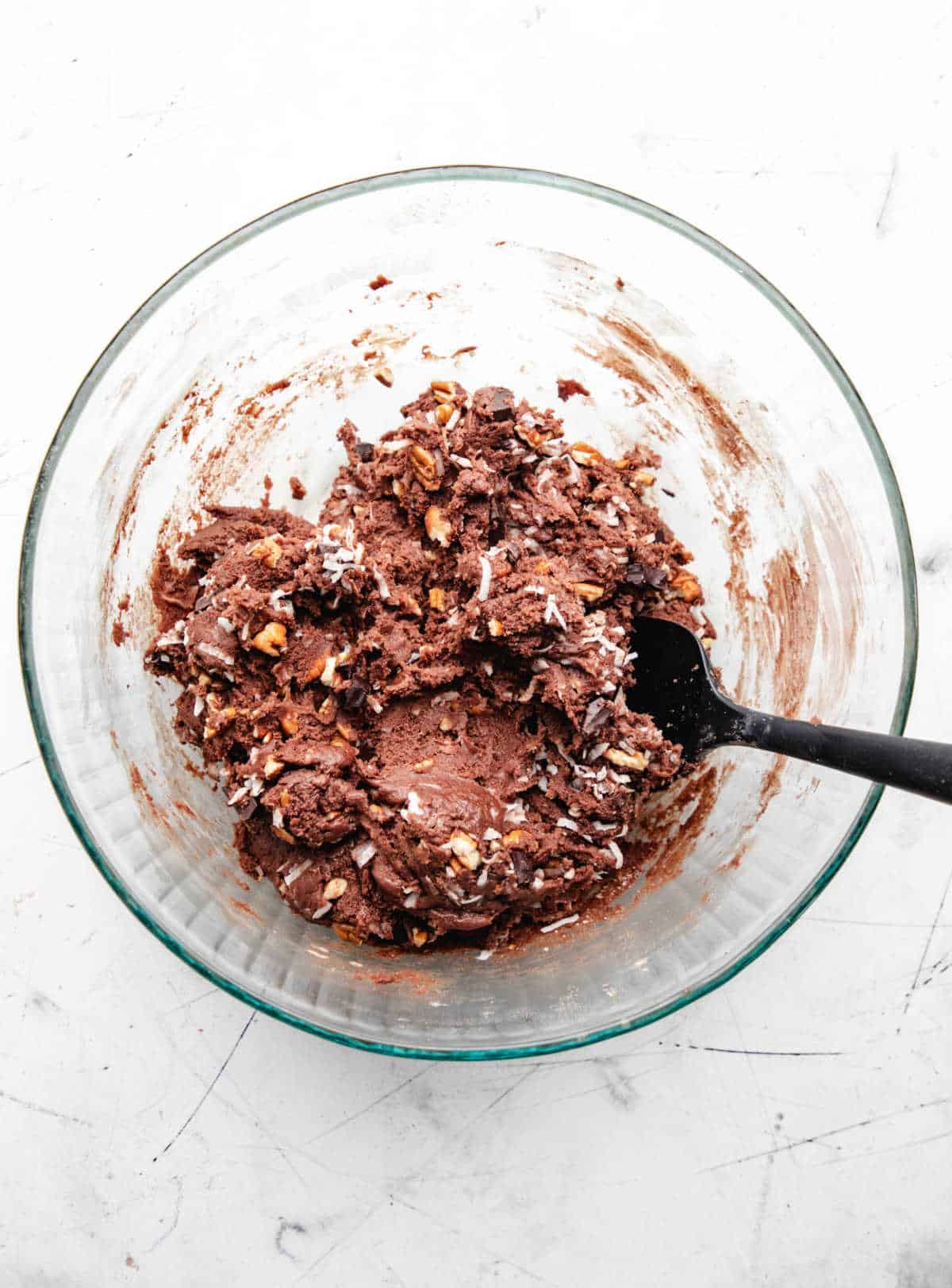 Chopped pecans coconut and chocolate chunks in German chocolate cookie dough.