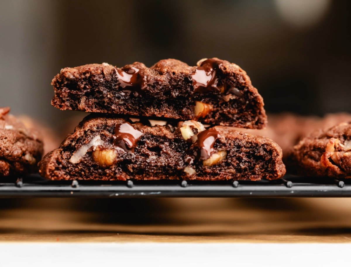 Half of a German chocolate chip cookie stacked on top of the other half. 