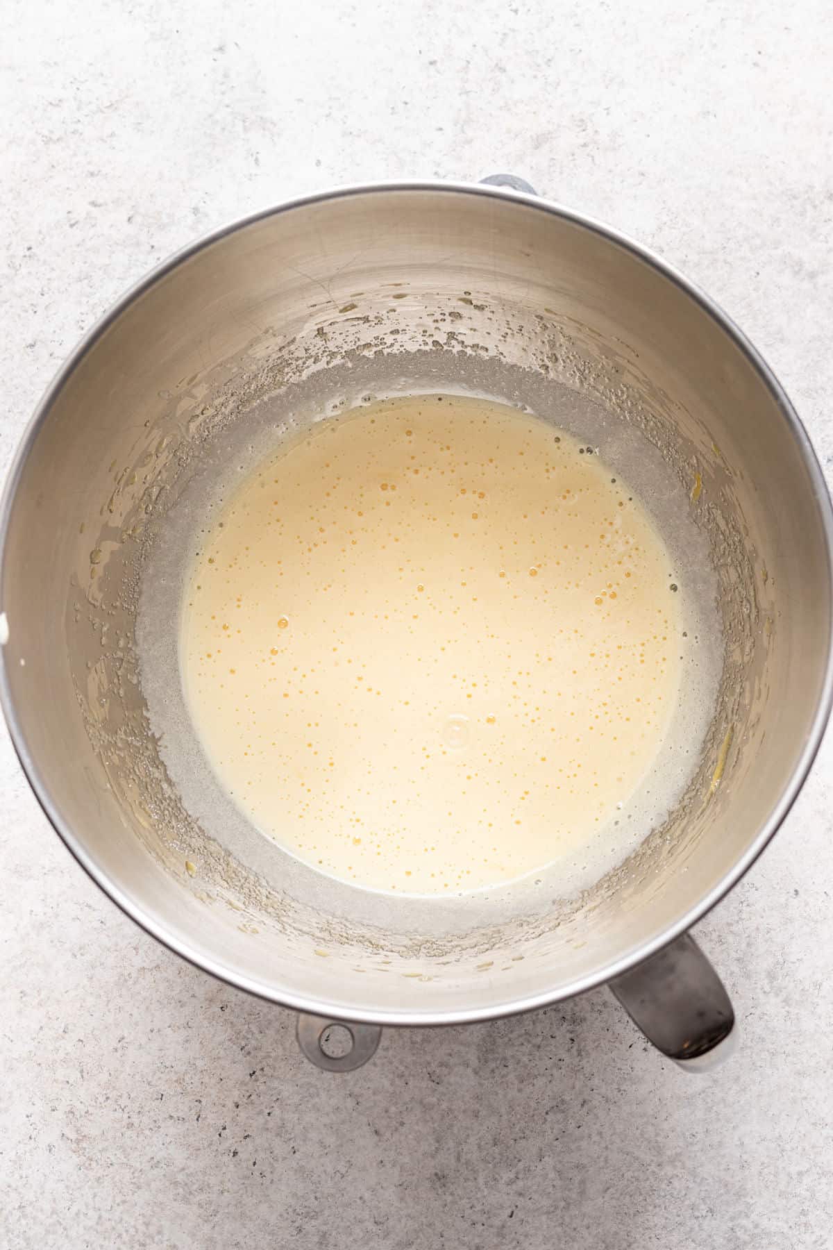 Eggs and sugar beaten until pale in a silver mixing bowl. 