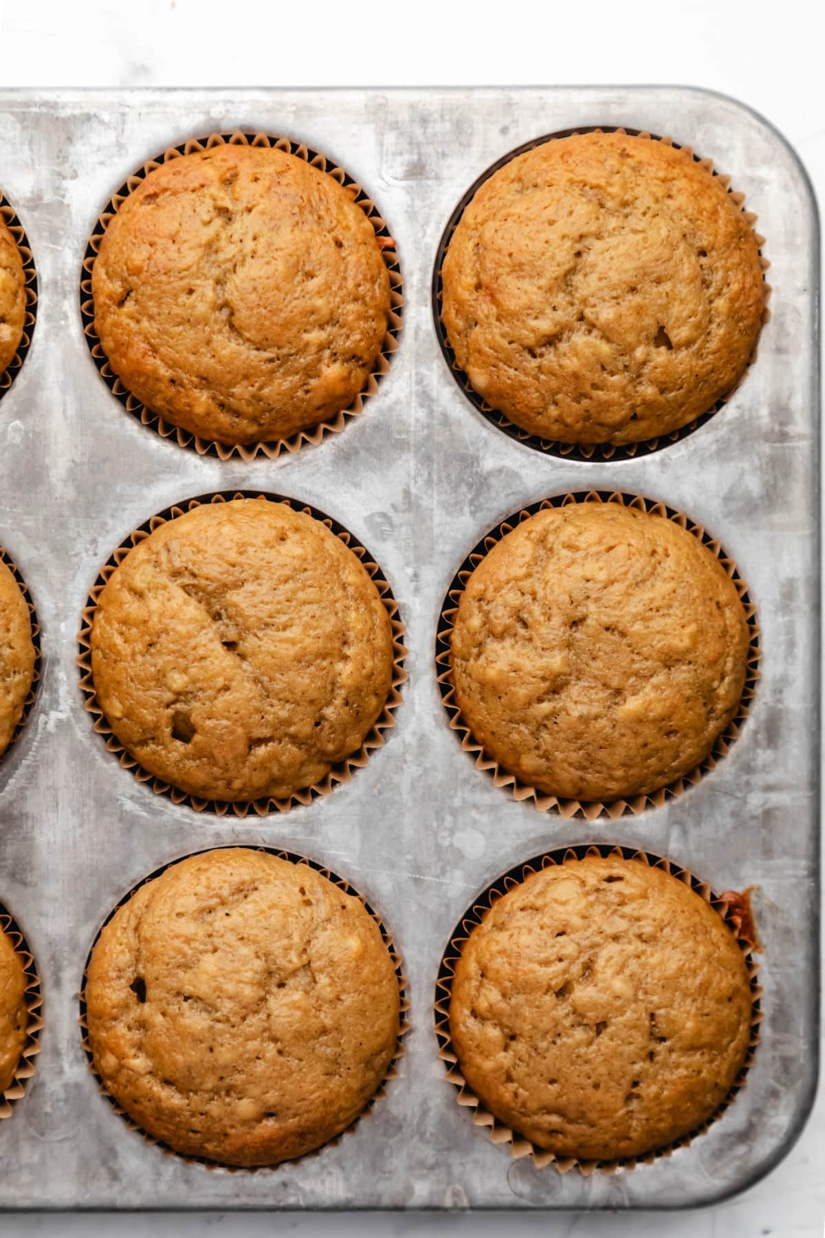 Baked banana muffins in a muffin tin. 