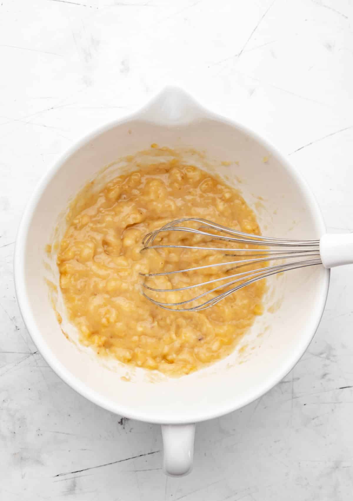 Mashed banana in a mixing bowl. 