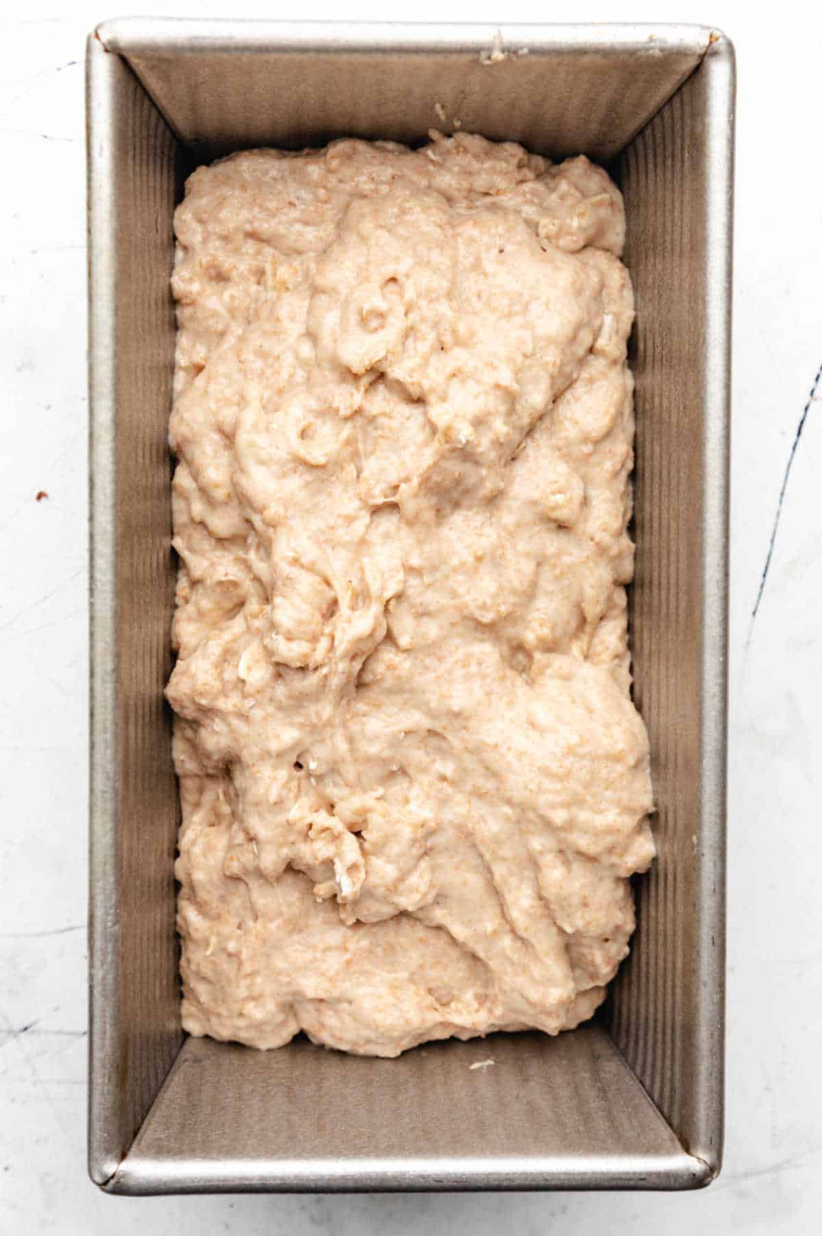 Honey oat bread batter in a loaf pan. 
