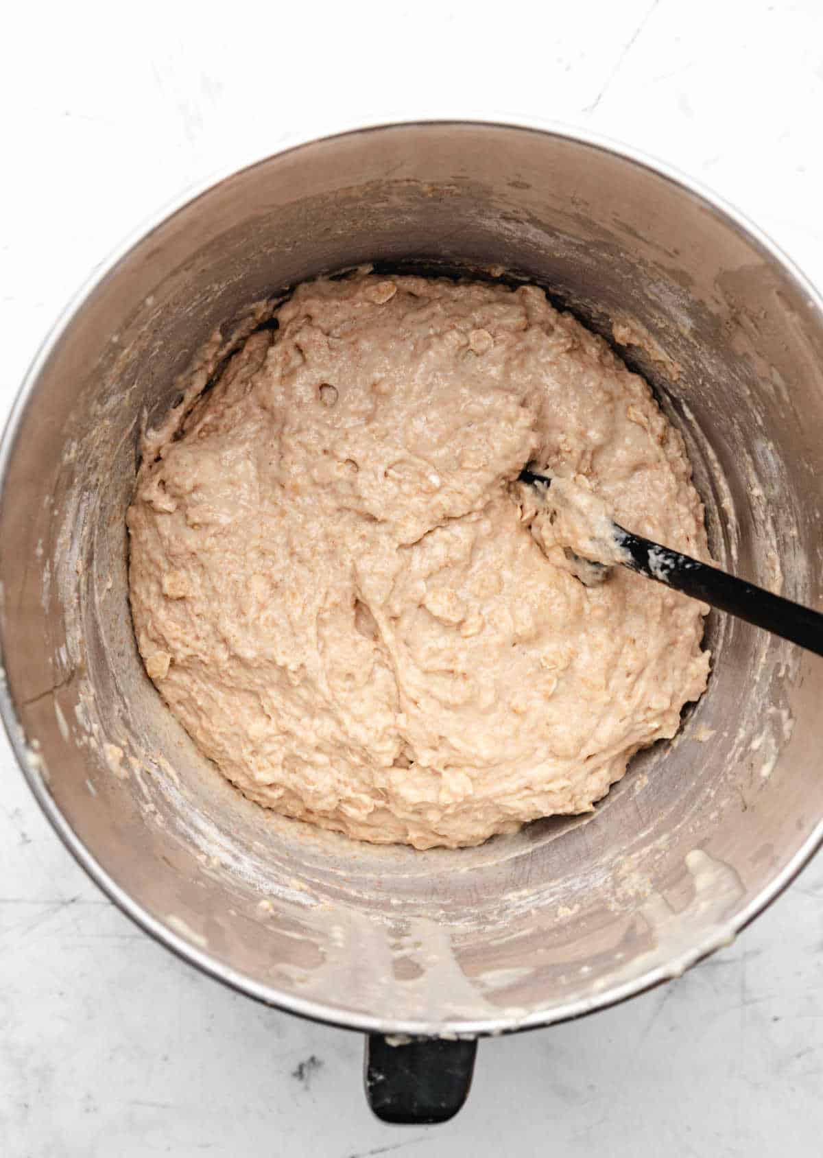 Dry ingredients mixed into wet ingredients for honey oat bread. 