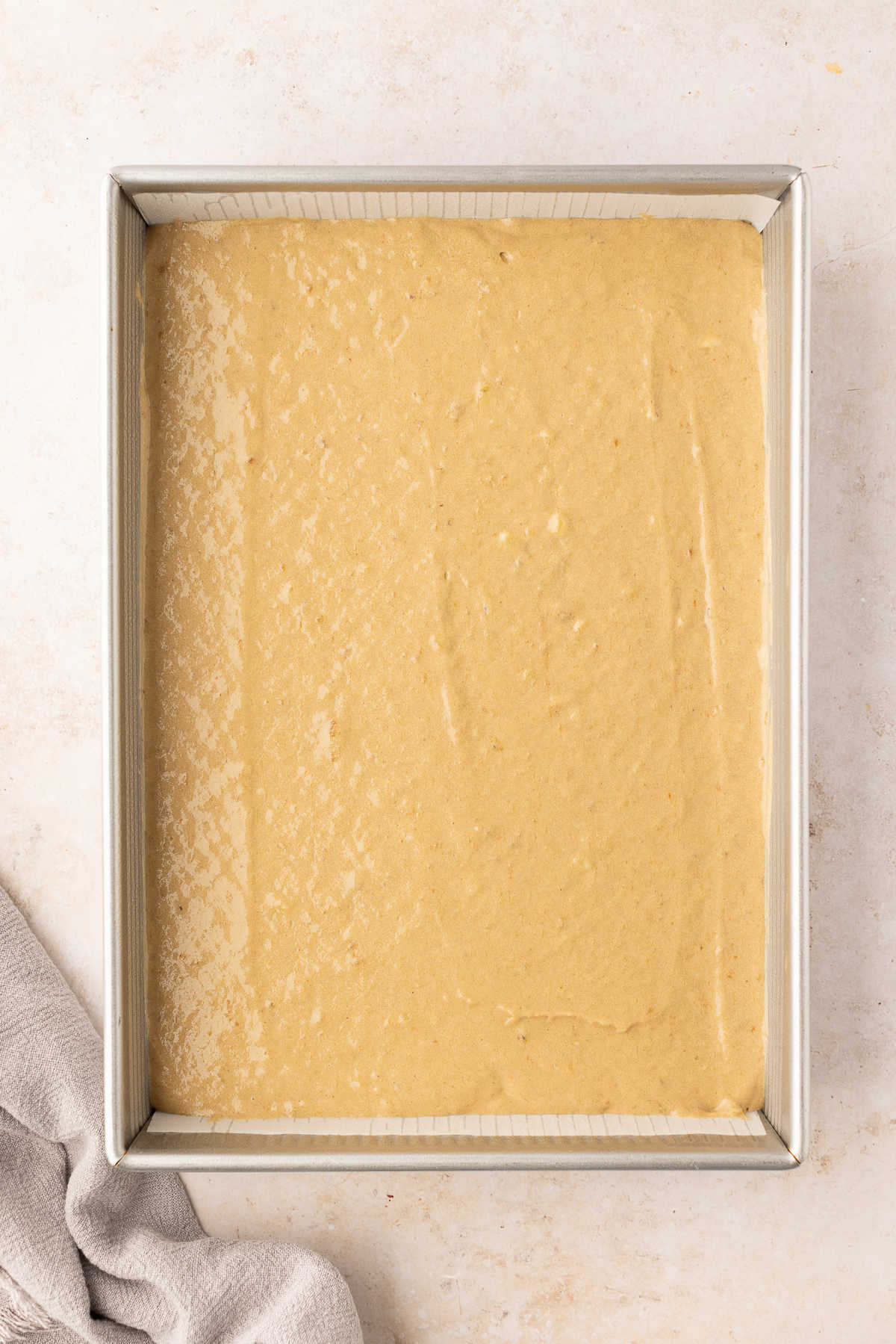 Banana cake batter in a rectangular cake pan.