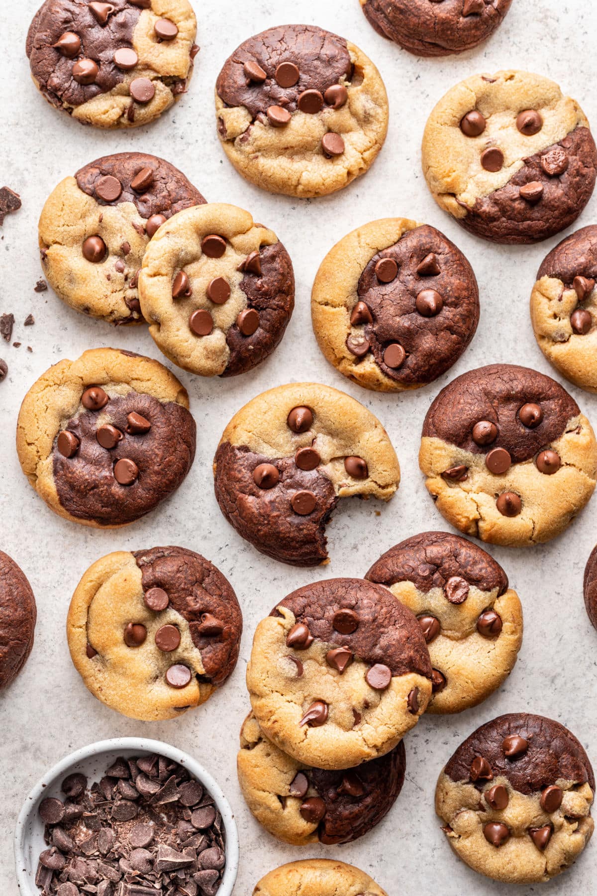 Overlapping brookies next to a dish of chocolate chips.