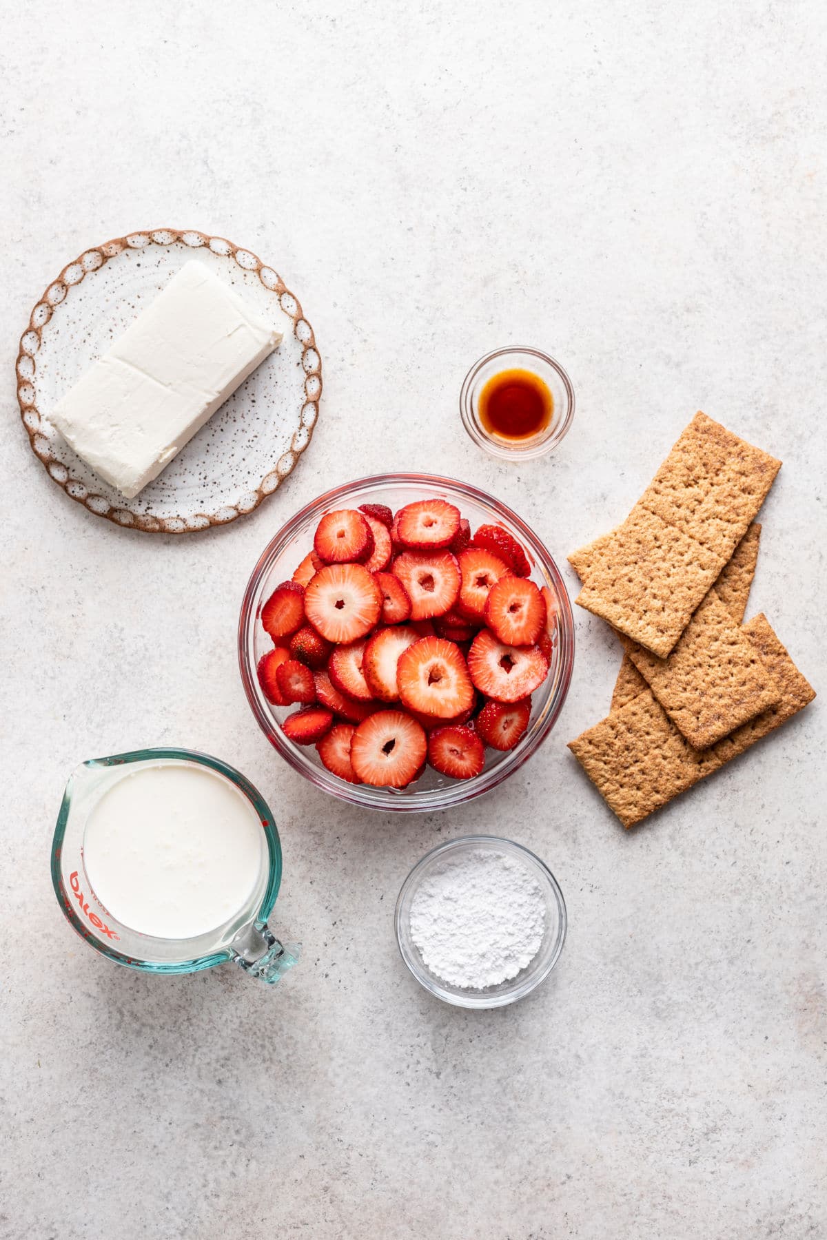 Ingredients for strawberry icebox cake in dishes. 