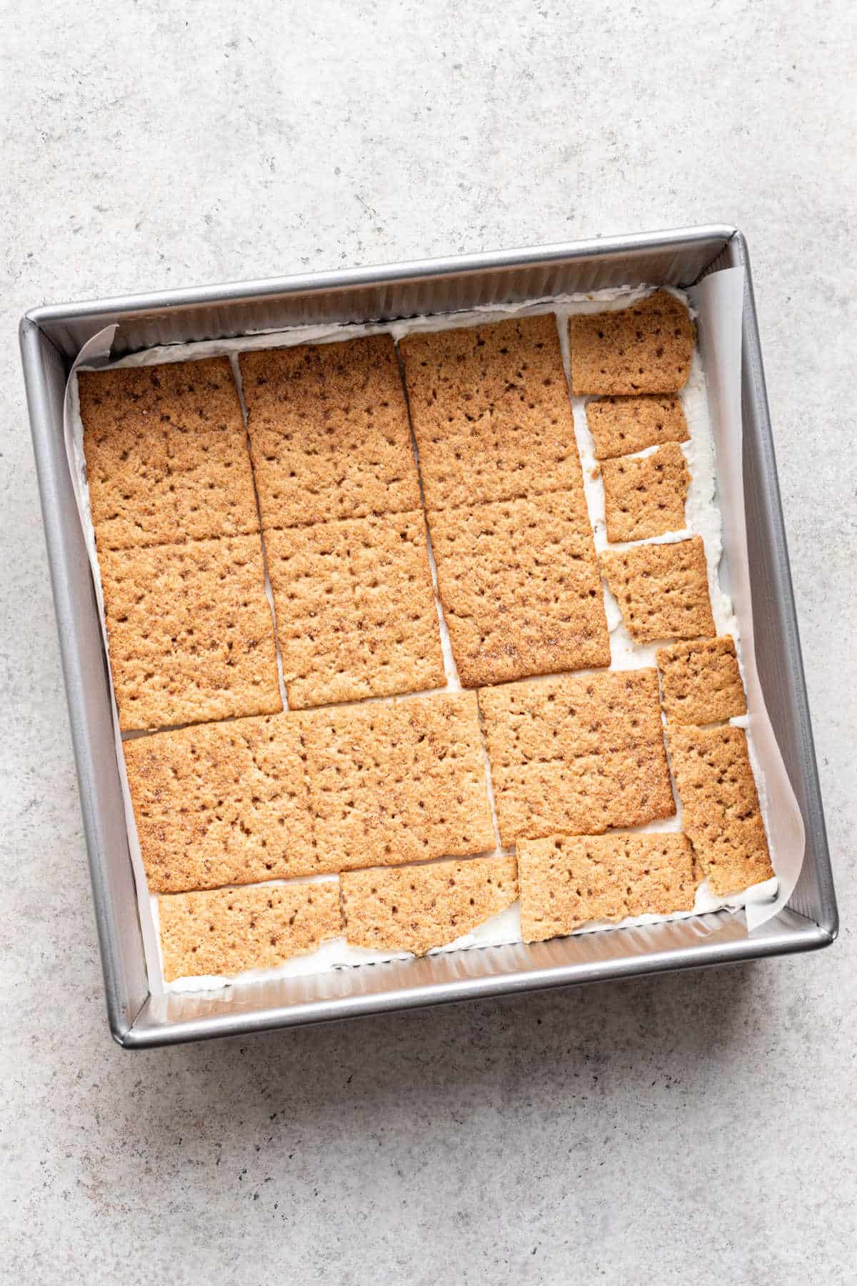 A layer of graham crackers over cream cheese whipped cream. 