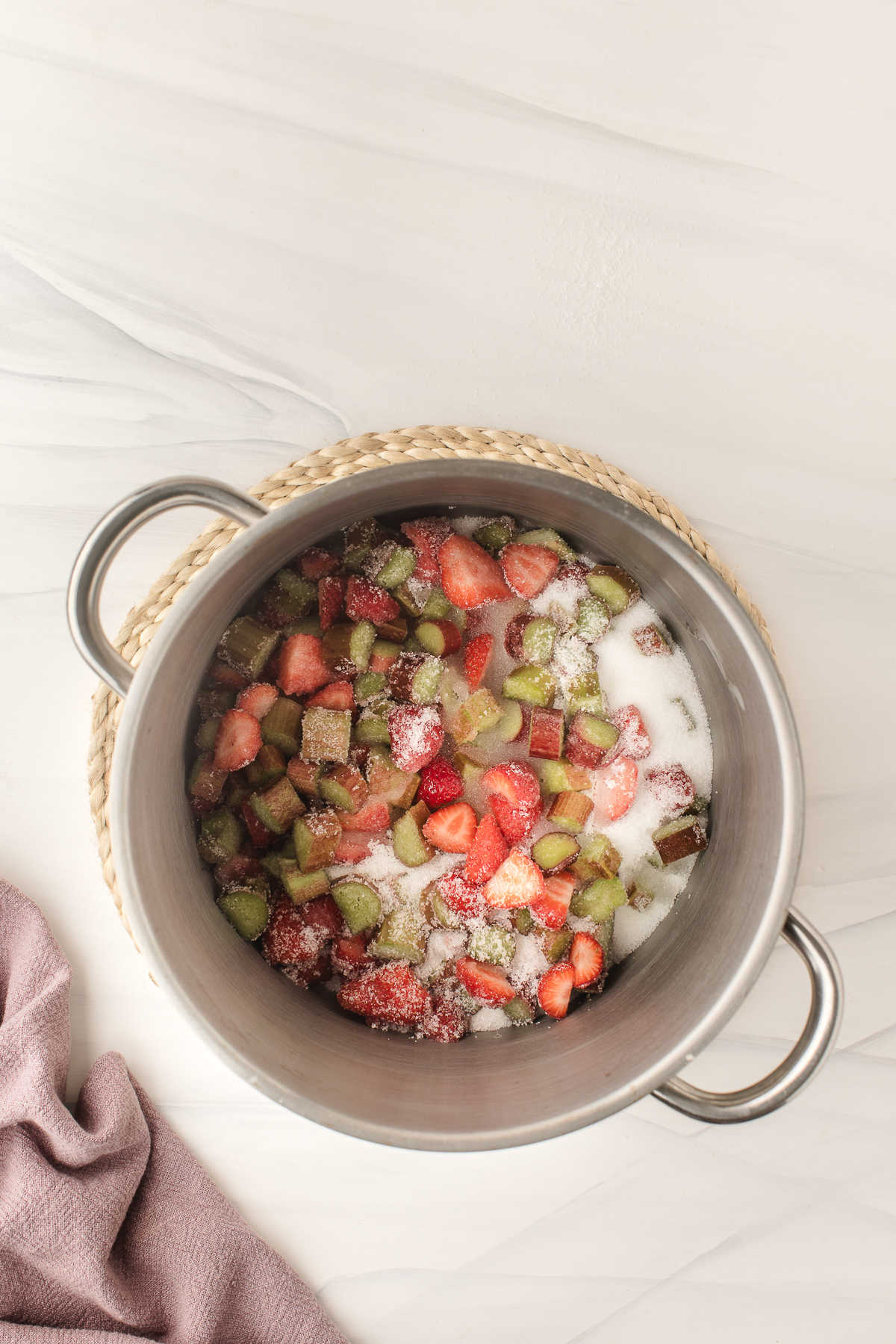 Strawberries, rhubarb, sugar, water, and lemon juice in a saucepot.
