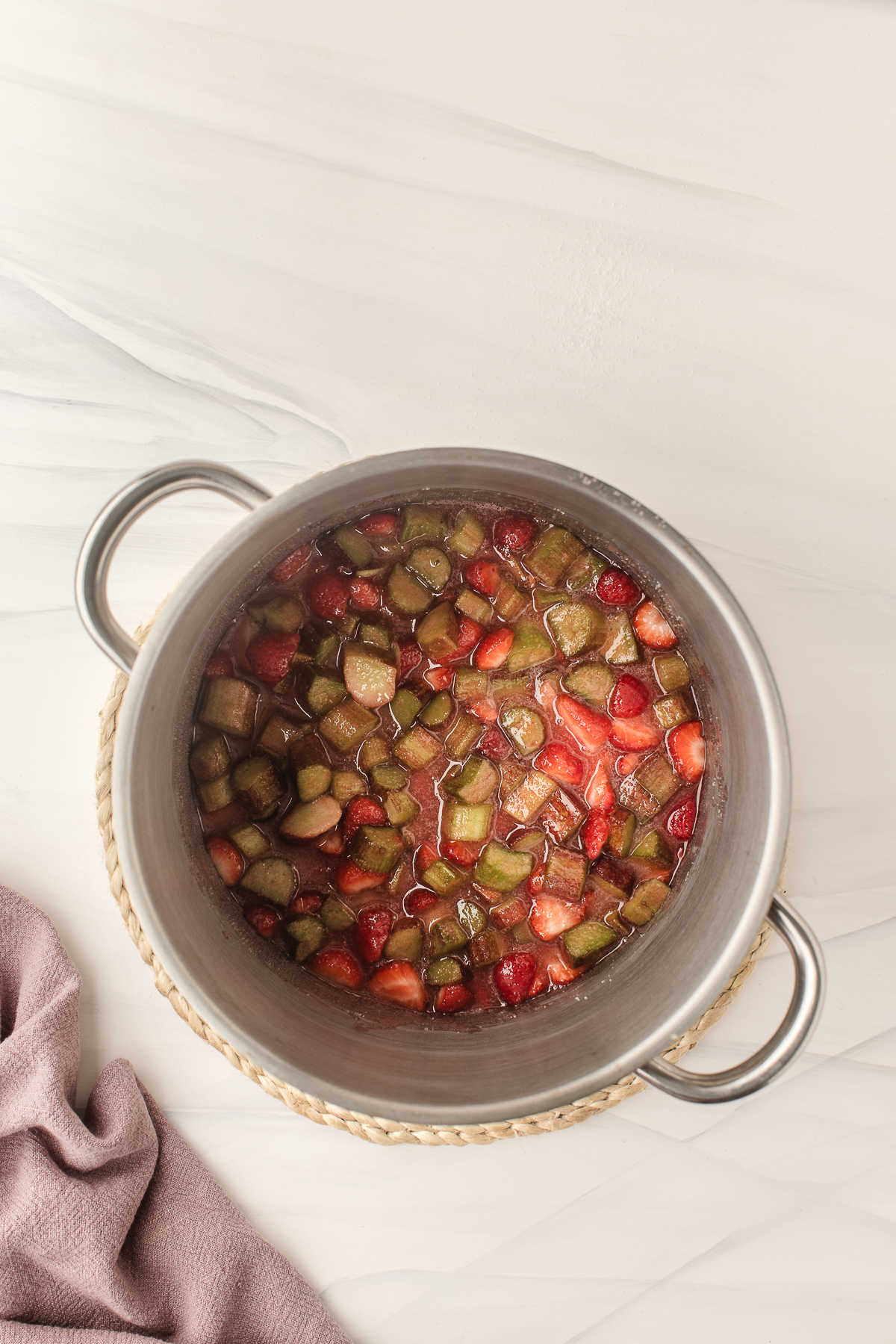 Rhubarb strawberry mixture cooking in a saucepot.