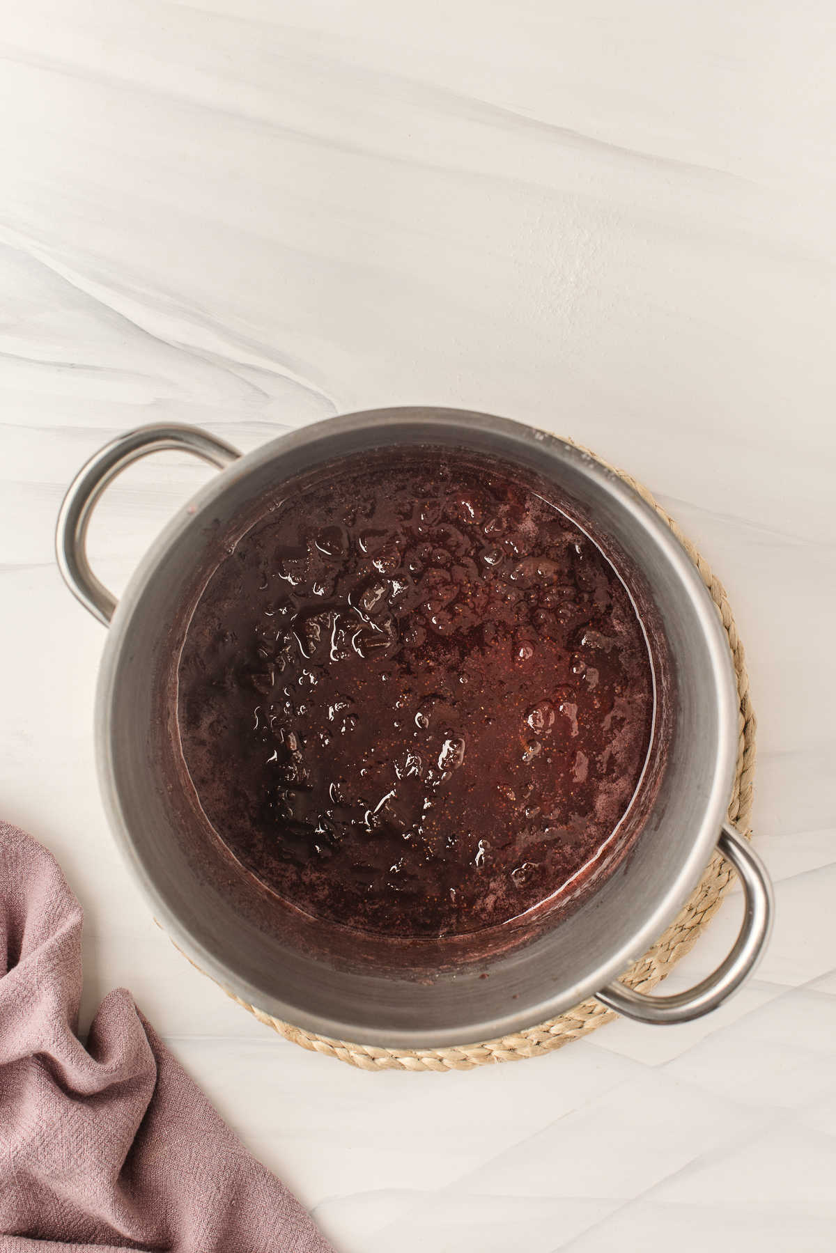 Cooked strawberry rhubarb jam in a saucepot. 