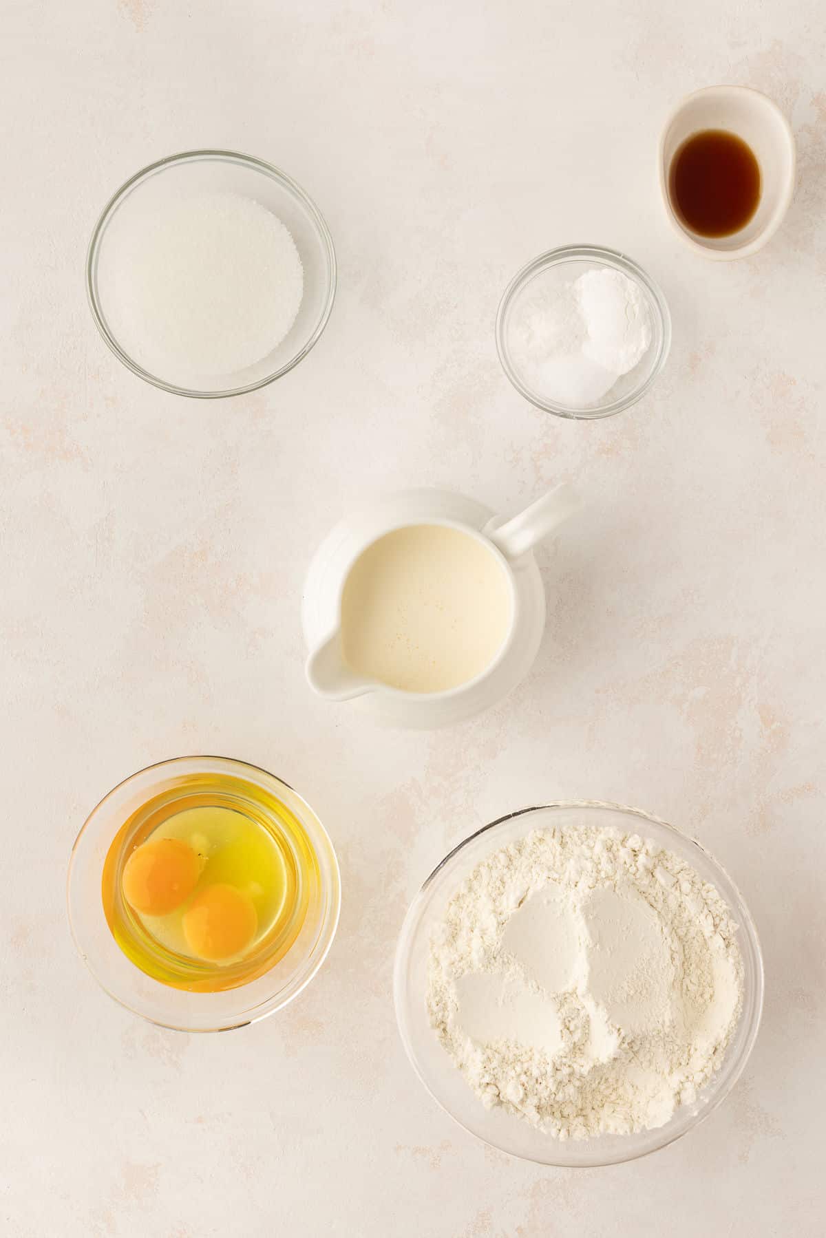 Ingredients for sweet cream pancakes in dishes.