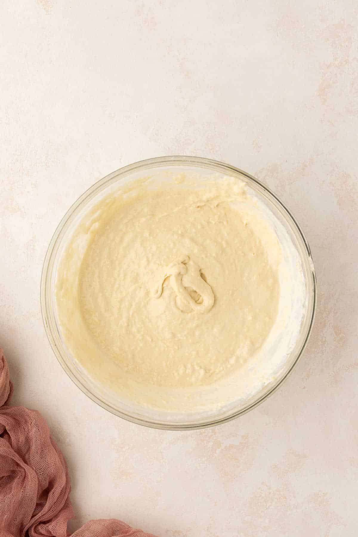 Sweet cream pancake batter in a glass mixing bowl.