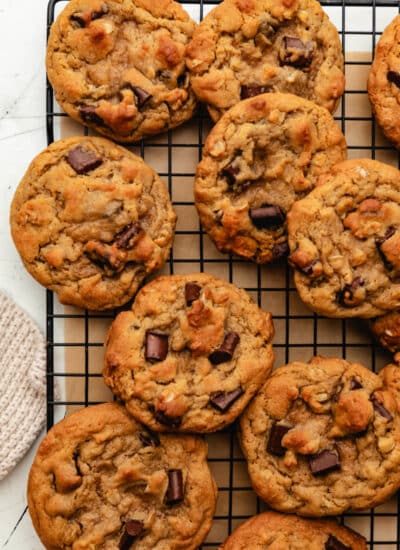 Overlapping Chick-fil-A chocolate chunk cookies on a wire cooling rack.