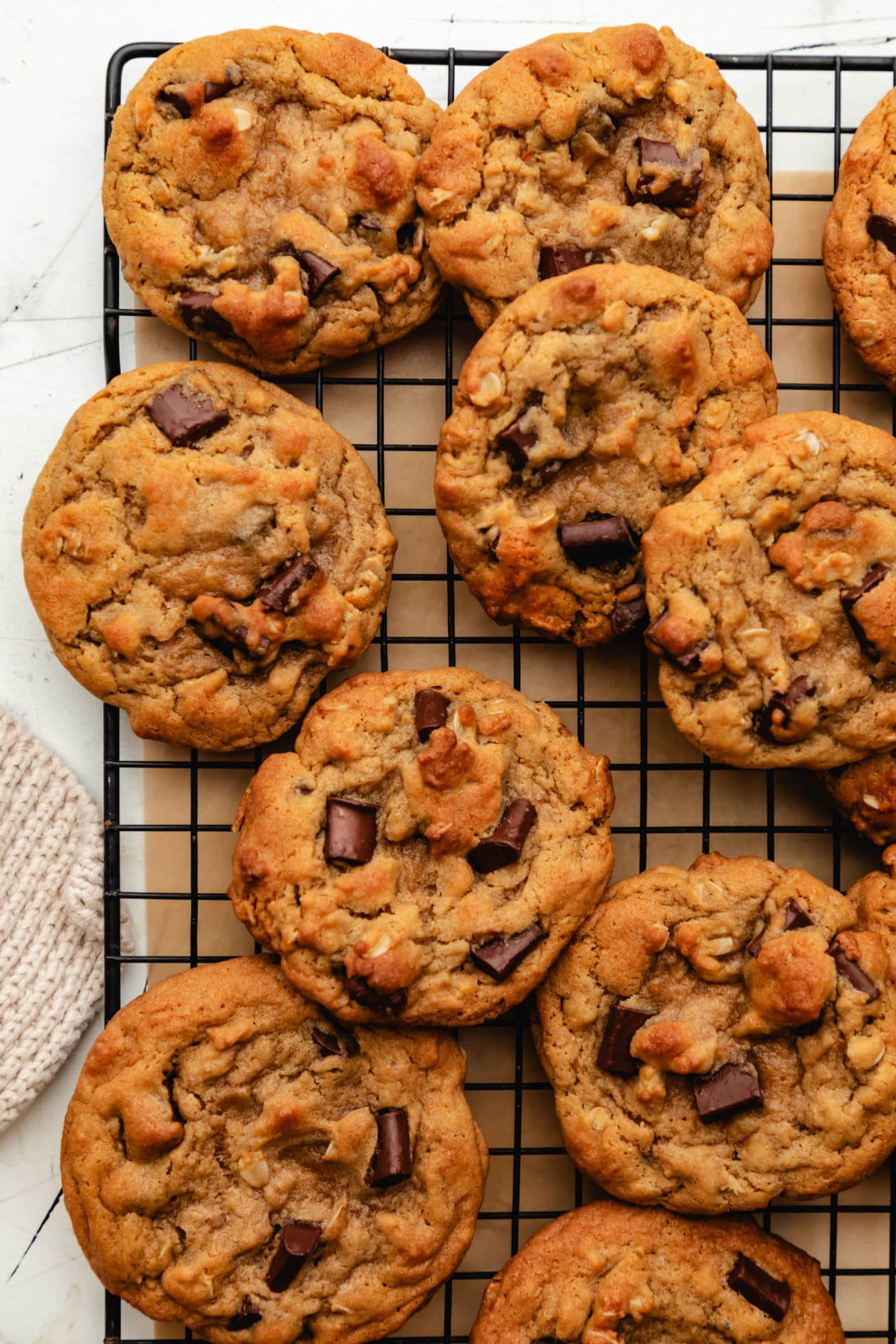 Overlapping Chick-fil-A chocolate chunk cookies on a wire cooling rack. 