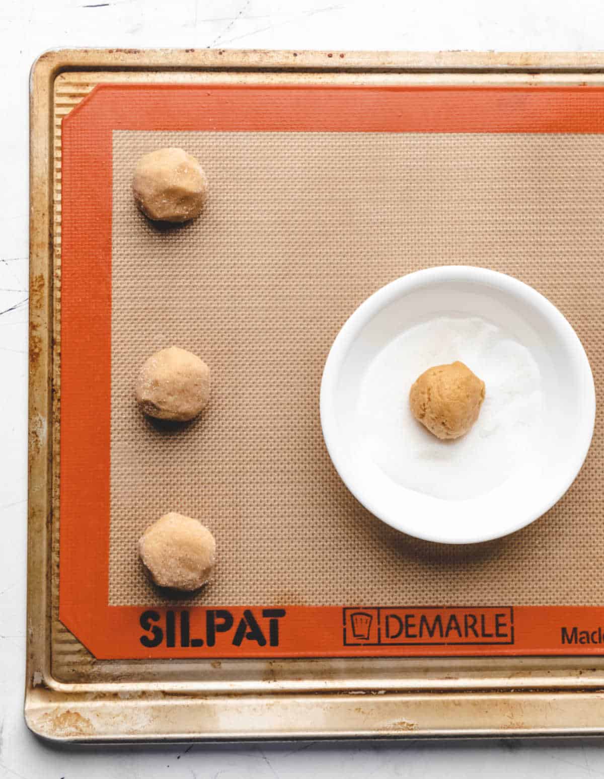Scoops of peanut butter cookie dough rolled in sugar.