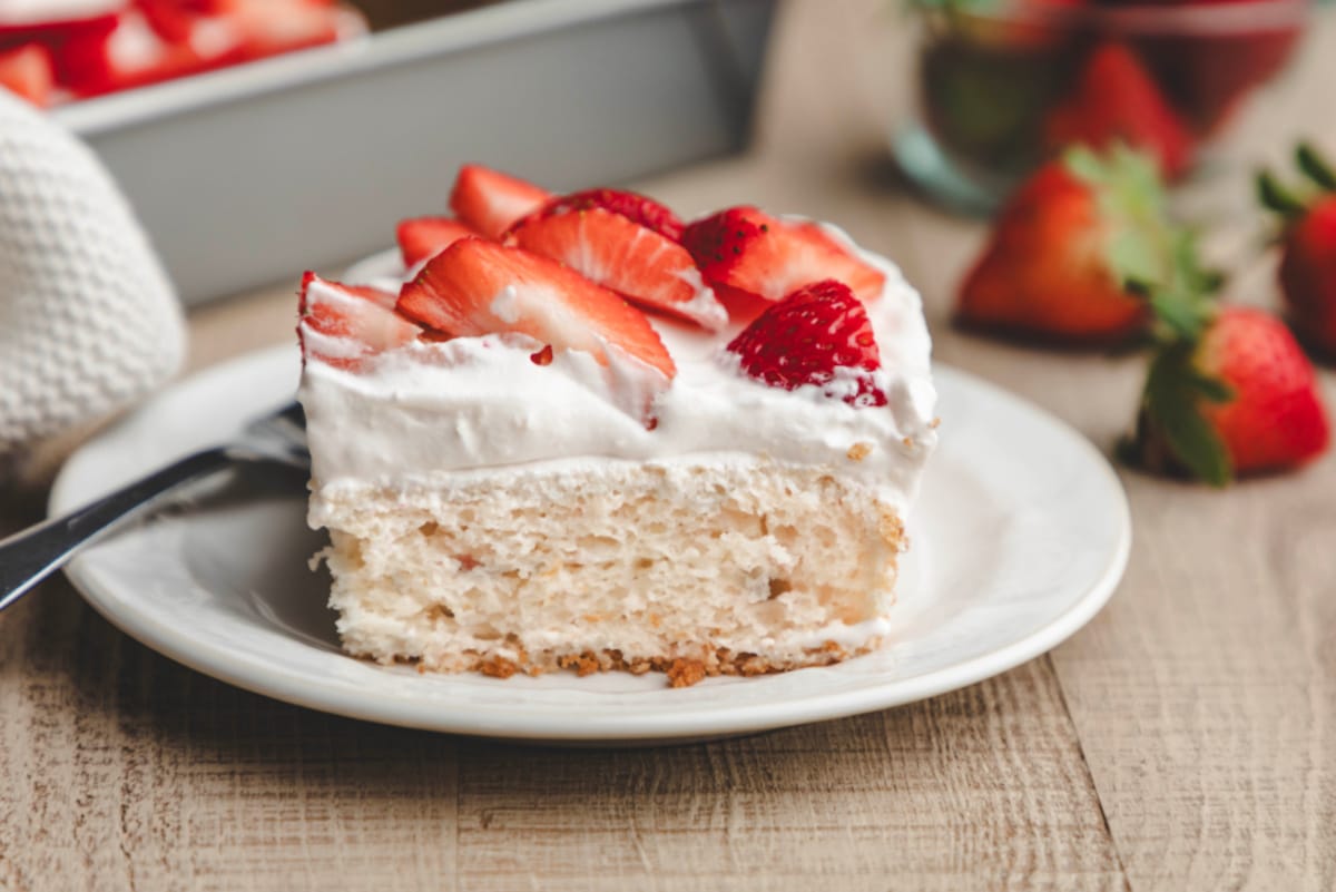 A slice of strawberry yogurt cake on a white plate. 