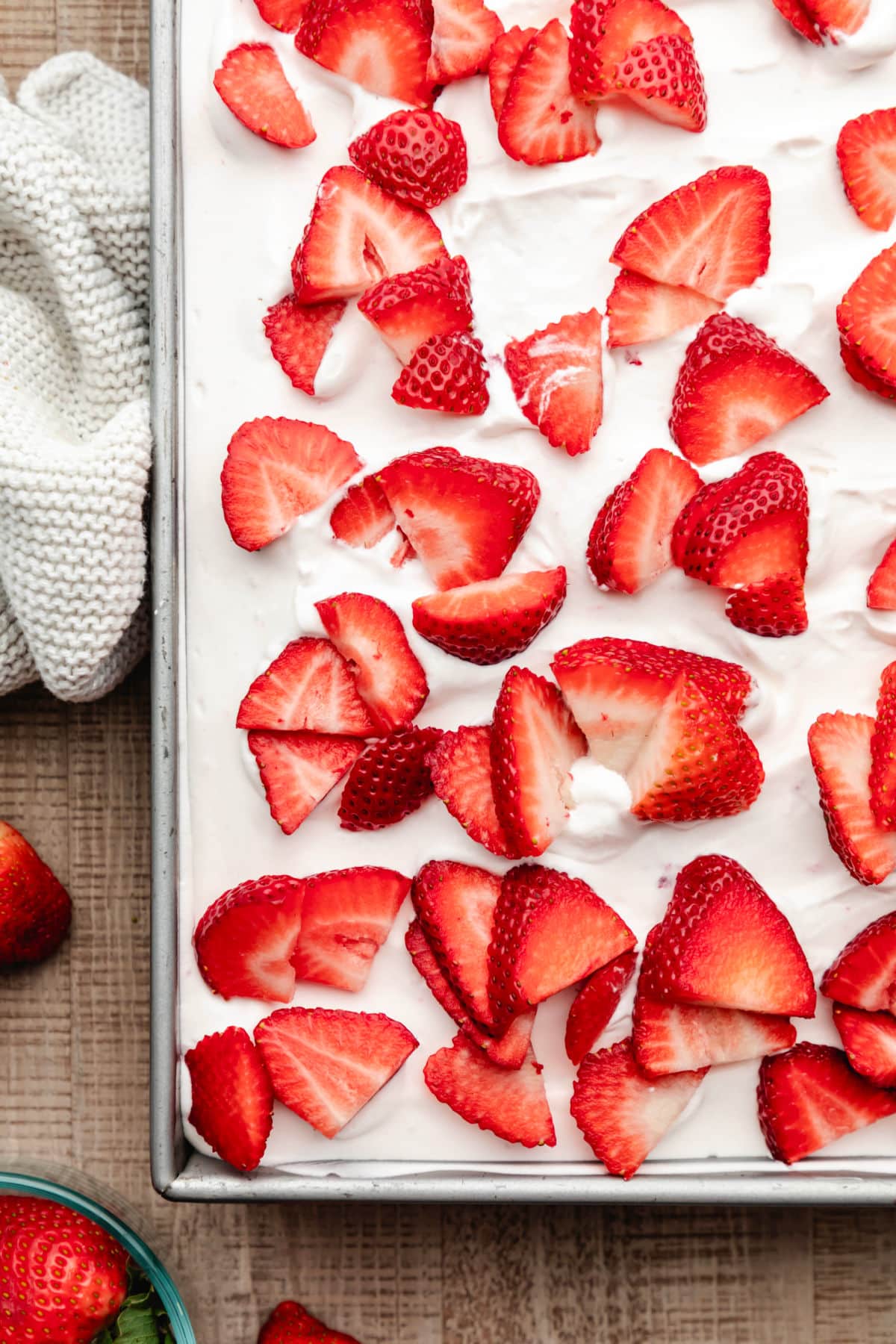 Sliced strawberries on top of strawberry yogurt cake. 