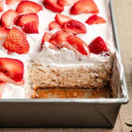 A piece of cake cut from the pan of strawberry yogurt cake.