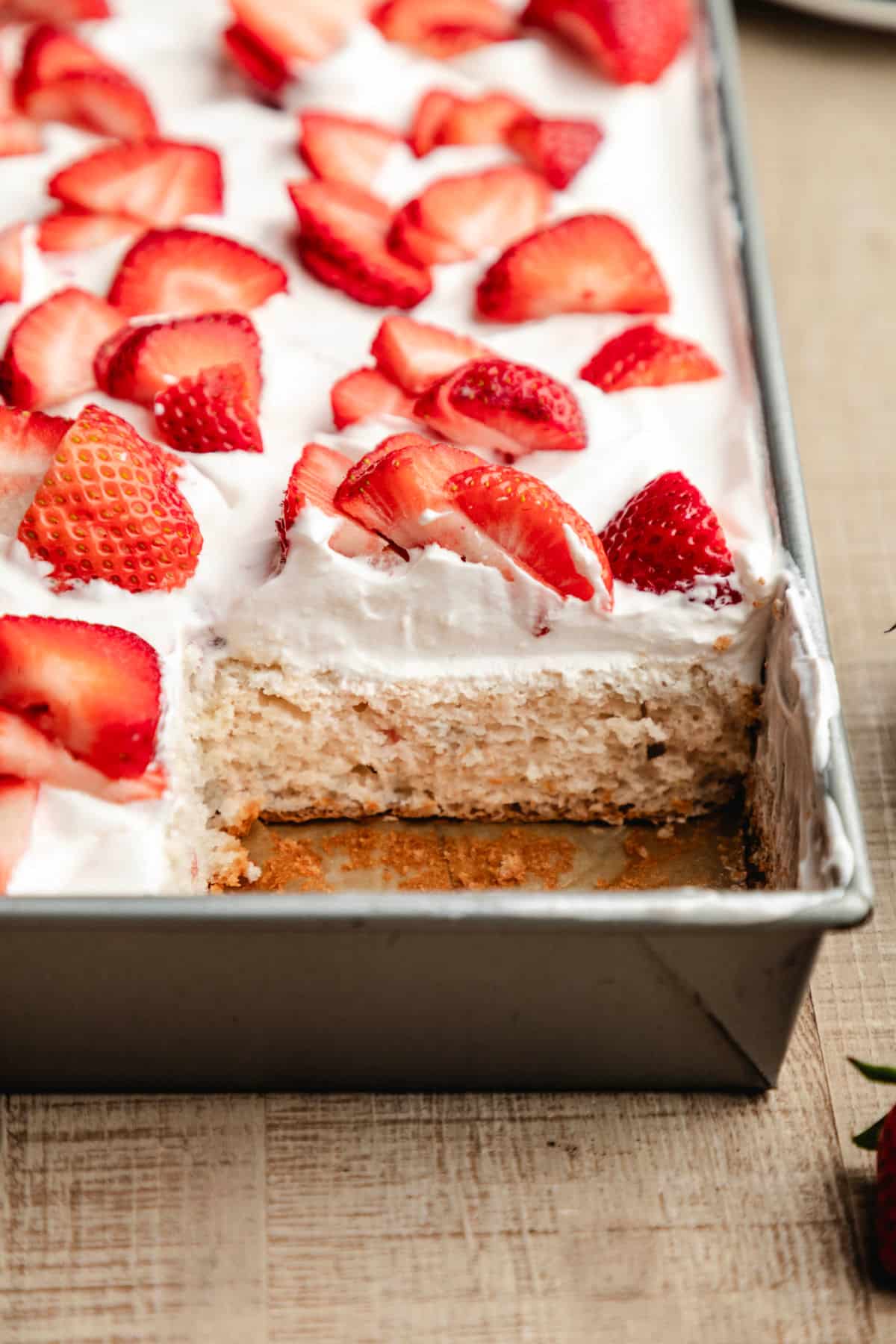 A piece of cake cut from the pan of strawberry yogurt cake.