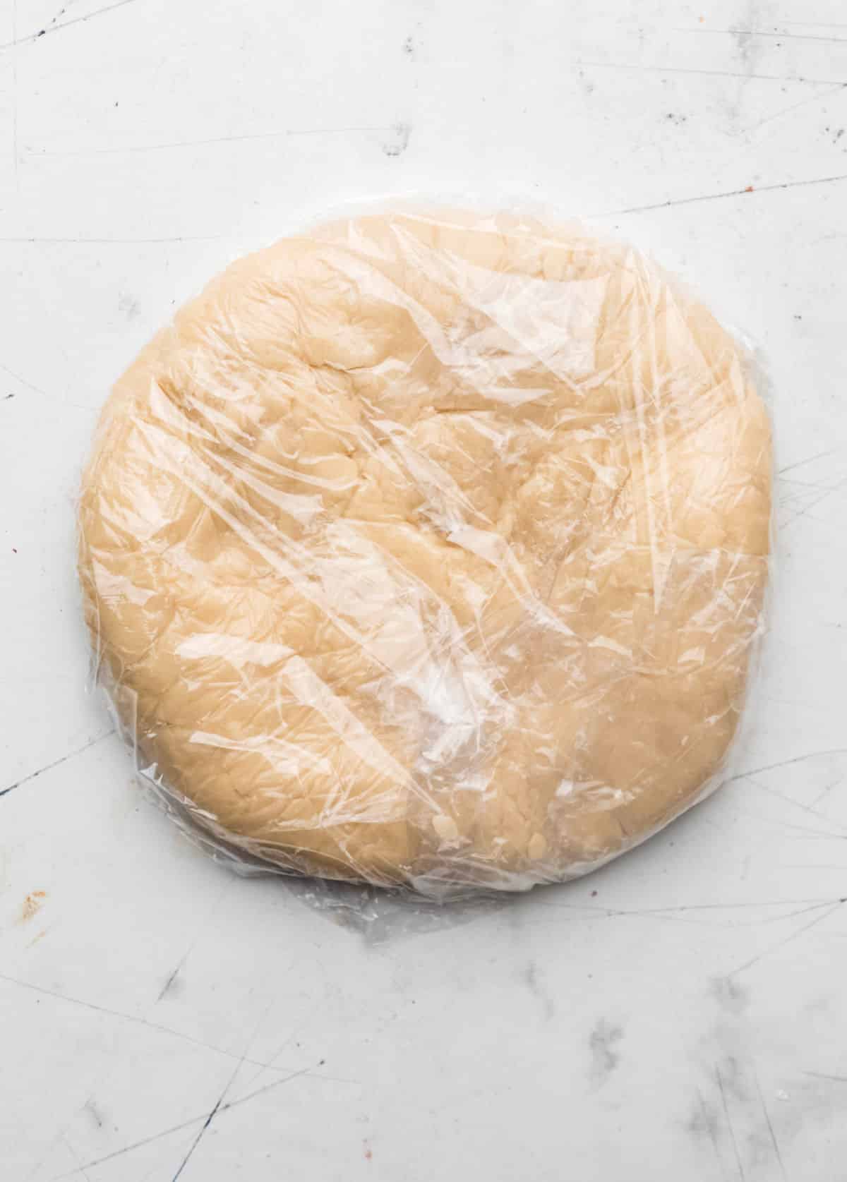 Wrapped sugar cookie dough in a disk.