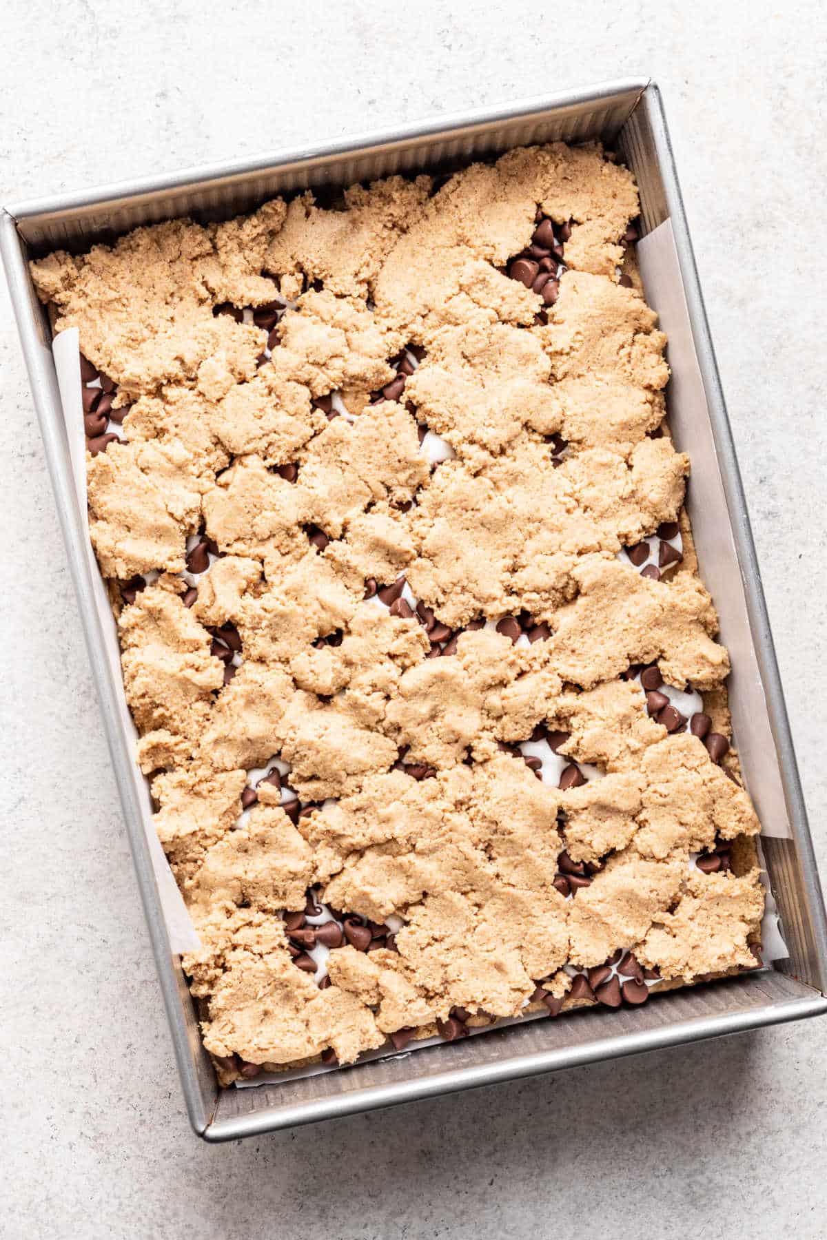 Half of the graham cracker dough on top of marshmallow creme and chocolate chips.