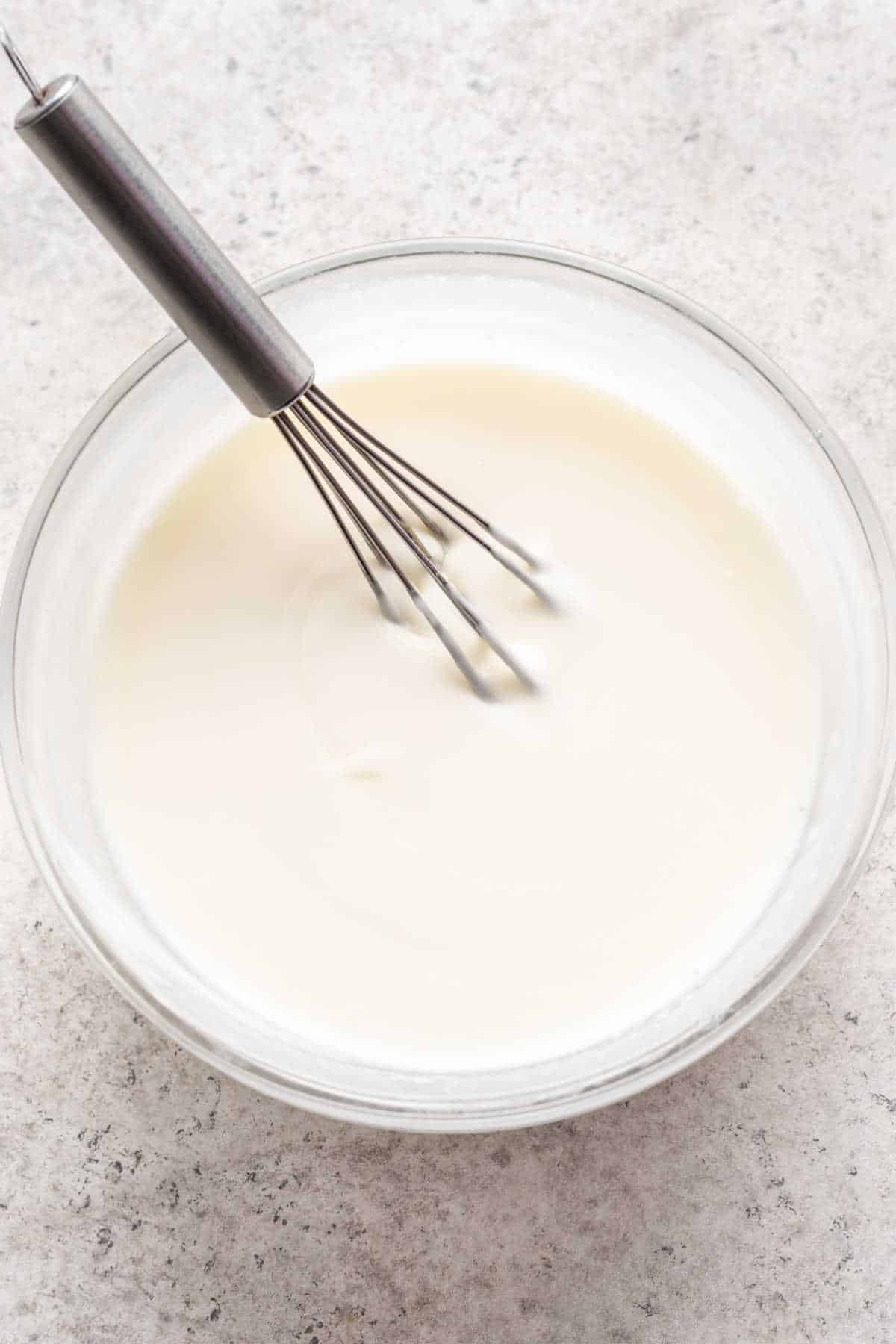 Icing for strawberry scones in a small mixing bowl.