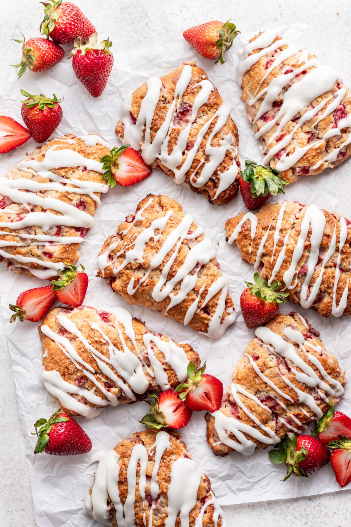 Strawberry scones on a piece of white parchment paper.