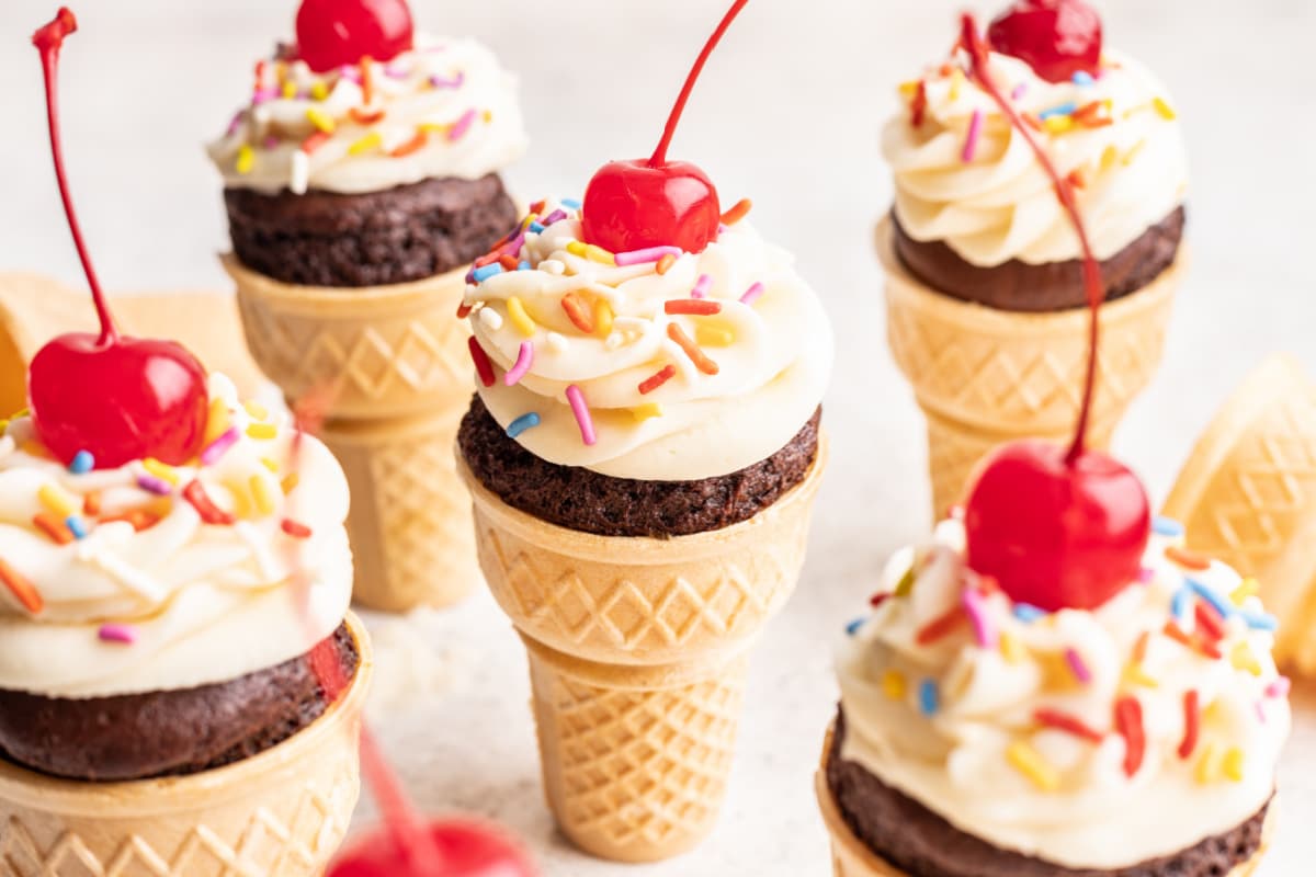 Ice cream cone cupcakes in a staggered row. 