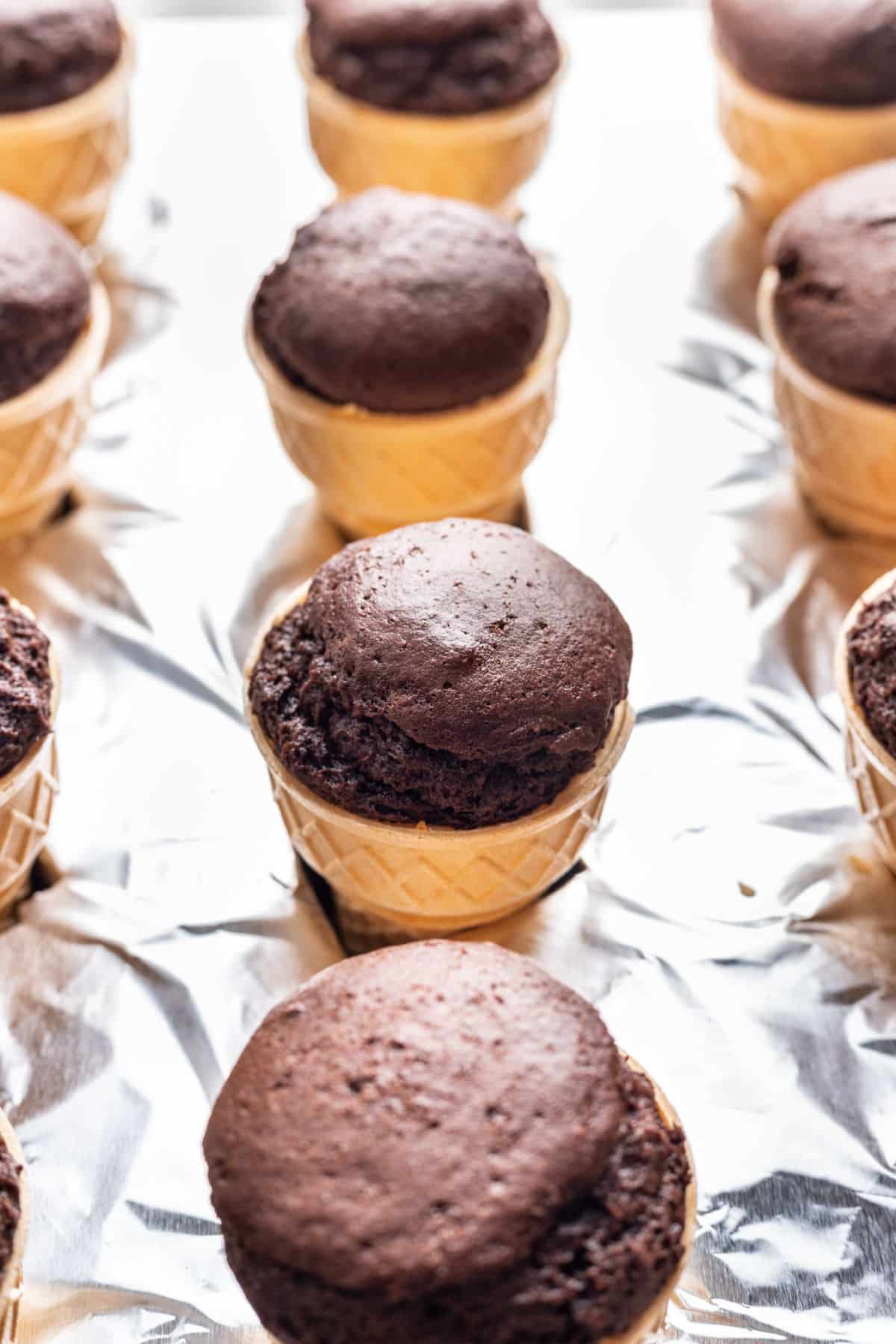 Baked ice cream cone cupcakes in a muffin tin.