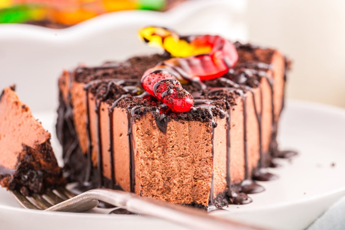 A slice of no bake dirt pie with a bite on a fork next to the slice.