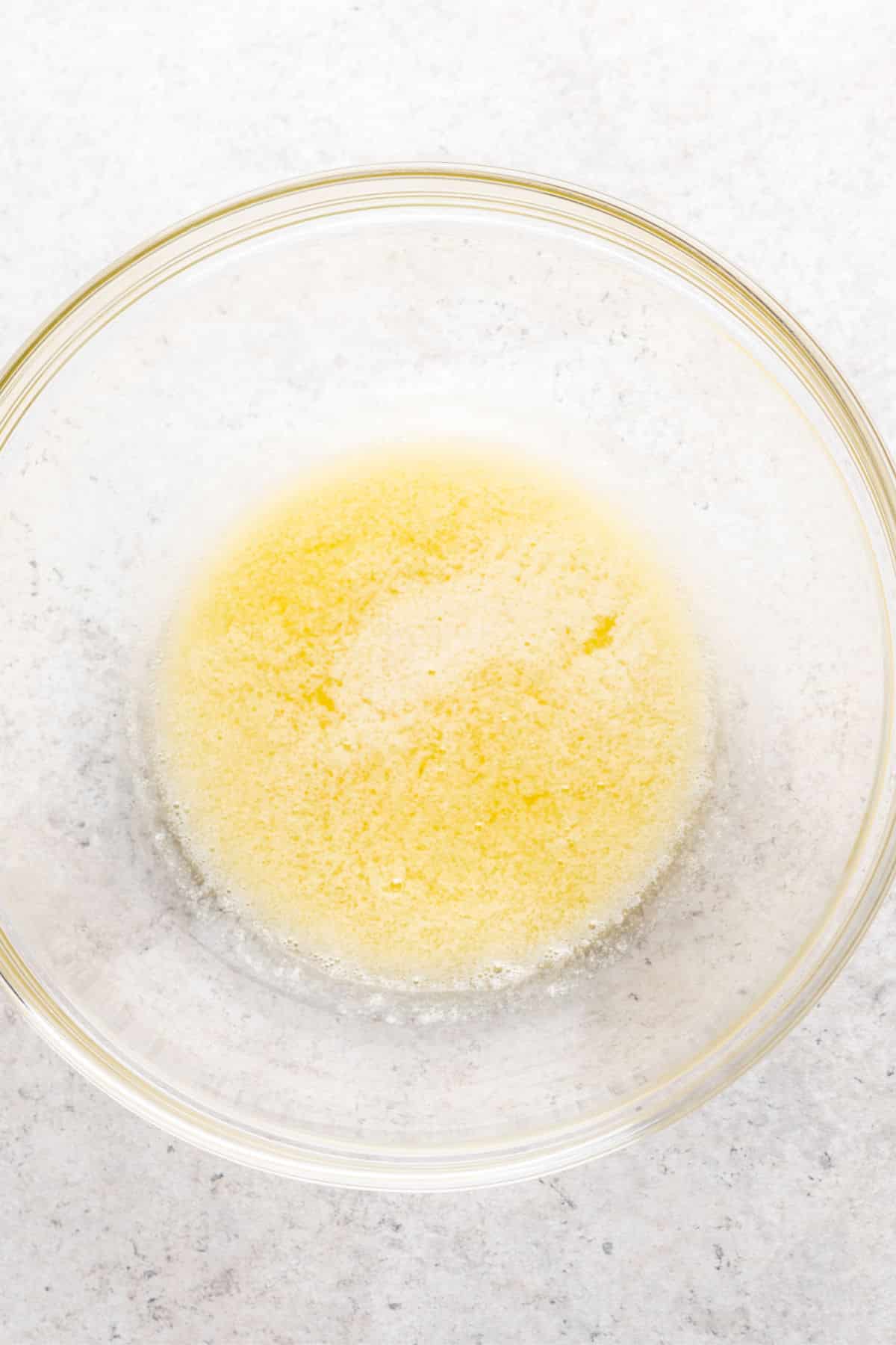 Melted butter in a glass bowl.